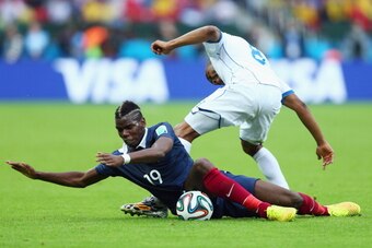 PORTO ALEGRE, BRAZIL - JUNE 15: Paul Pogba of France battles for the ball with Wilson Palacios of Honduras during the 2014 FIFA World Cup Brazil Group E match between France and Honduras at Estadio Beira-Rio on June 15, 2014 in Porto Alegre, Brazil.  (Pho