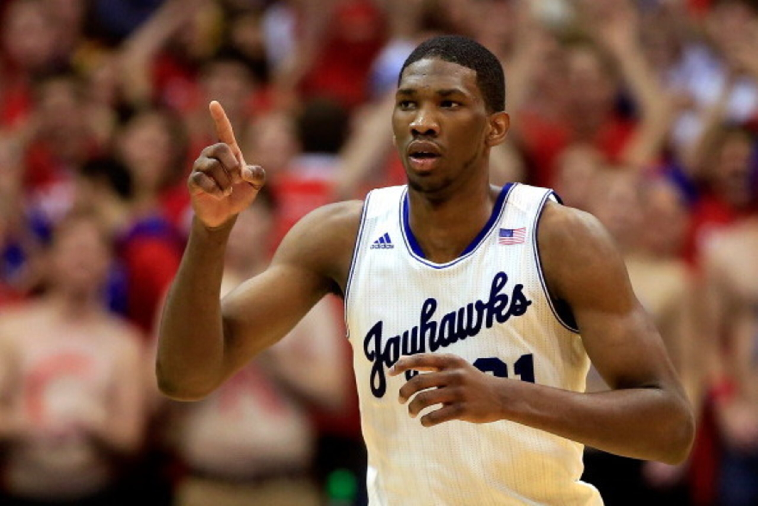 LAWRENCE, KS - JANUARY 18:  Joel Embiid #21 of the Kansas Jayhawks reacts after scoring during the game against the Oklahoma State Cowboys at Allen Fieldhouse on January 18, 2014 in Lawrence, Kansas.  (Photo by Jamie Squire/Getty Images)