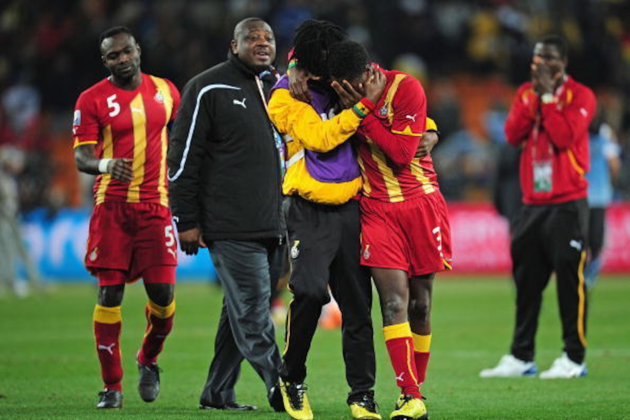 JOHANNESBURG, SOUTH AFRICA - JULY 02:  Asamoah Gyan of Ghana is consoled after his team are knocked out in a penalty shoot out during the 2010 FIFA World Cup South Africa Quarter Final match between Uruguay and Ghana at the Soccer City stadium on July 2, 