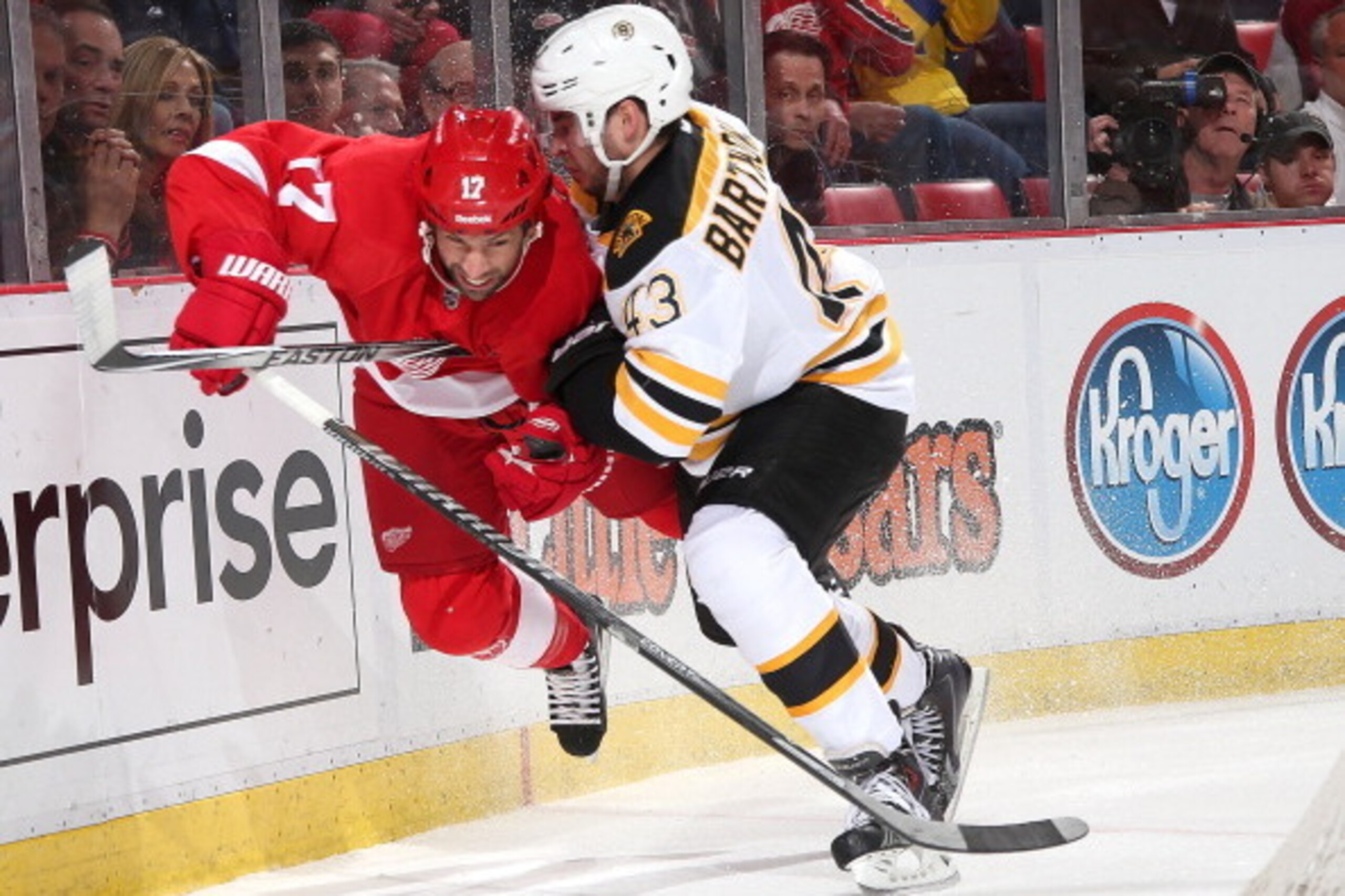 DETROIT, MI - APRIL 24:  Matt Bartkowski #43 of the Boston Bruins knocks David Legwand #17 of the Detroit Red Wings off the puck during Game Four of the First Round of the 2014 Stanley Cup Playoffs on April 24, 2014 at Joe Louis Arena in Detroit, Michigan
