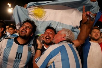 RIO DE JANEIRO, BRAZIL - JUNE 15:  Argentine soccer fans cheer their team's second goal against Bosnia and Herzegovina as they watch on a giant screen at the FIFA World Cup Fan Fest on Copacabana beach on June 15, 2014 in Rio de Janeiro, Brazil. The Argen