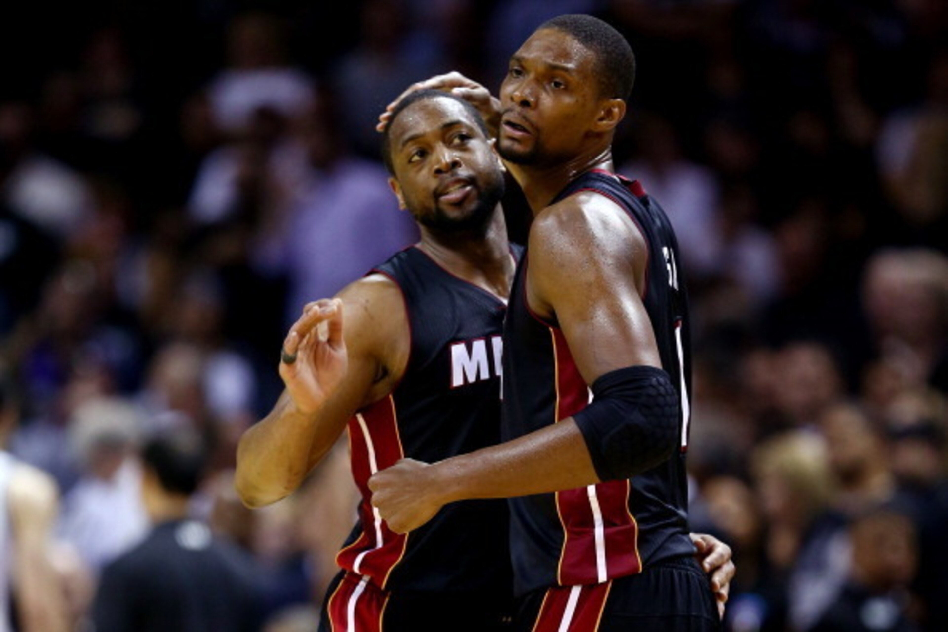 SAN ANTONIO, TX - JUNE 08:  Chris Bosh #1 of the Miami Heat celebrates with Dwyane Wade #3 against the San Antonio Spurs during Game Two of the 2014 NBA Finals at the AT&T Center on June 8, 2014 in San Antonio, Texas. The Miami Heat defeated the San Anton