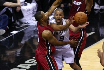 SAN ANTONIO, TX - JUNE 5: Tony Parker #9 of the San Antonio Spurs passes the ball around Rashard Lewis #9 of the Miami Heat in Game One of the 2014 NBA Finals at the AT&T Center on June 5, 2014 in San Antonio, Texas. NOTE TO USER: User expressly acknowled