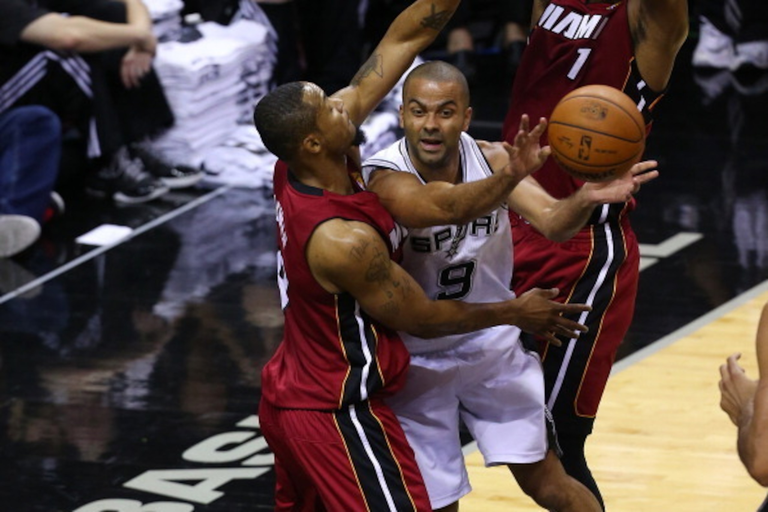SAN ANTONIO, TX - JUNE 5: Tony Parker #9 of the San Antonio Spurs passes the ball around Rashard Lewis #9 of the Miami Heat in Game One of the 2014 NBA Finals at the AT&T Center on June 5, 2014 in San Antonio, Texas. NOTE TO USER: User expressly acknowled