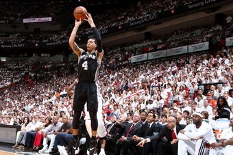MIAMI, FL - JUNE 12: Miami Heat players watch as Danny Green #4 of the San Antonio Spurs shoots a three pointer during Game Four of the 2014 NBA Finals at American Airlines Arena in Miami, Florida on June 12, 2014.  NOTE TO USER: User expressly acknowledg