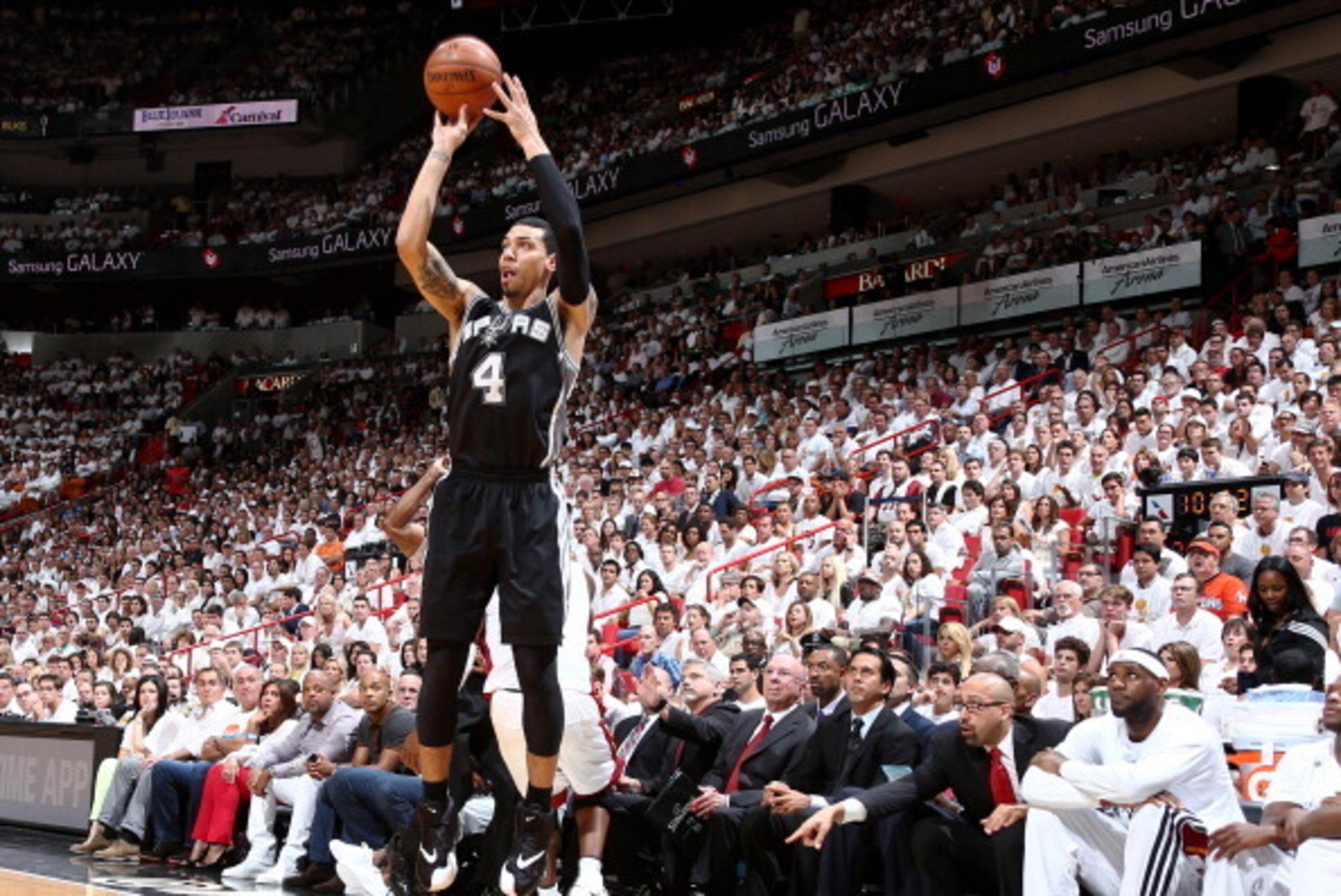 MIAMI, FL - JUNE 12: Miami Heat players watch as Danny Green #4 of the San Antonio Spurs shoots a three pointer during Game Four of the 2014 NBA Finals at American Airlines Arena in Miami, Florida on June 12, 2014.  NOTE TO USER: User expressly acknowledg