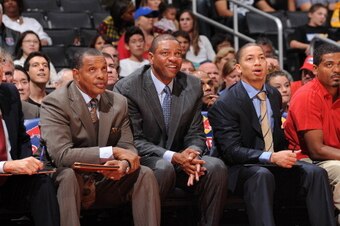 LOS ANGELES, CA - OCTOBER 18: Doc Rivers (C) of the Los Angeles Clippers sits with (L-R) assistant coach Kevin Eastman, Alvin Gentry, Tyronn Lue, and head athletic trainer Jasen Powell during their game against the Portland Trail Blazers at Staples Center