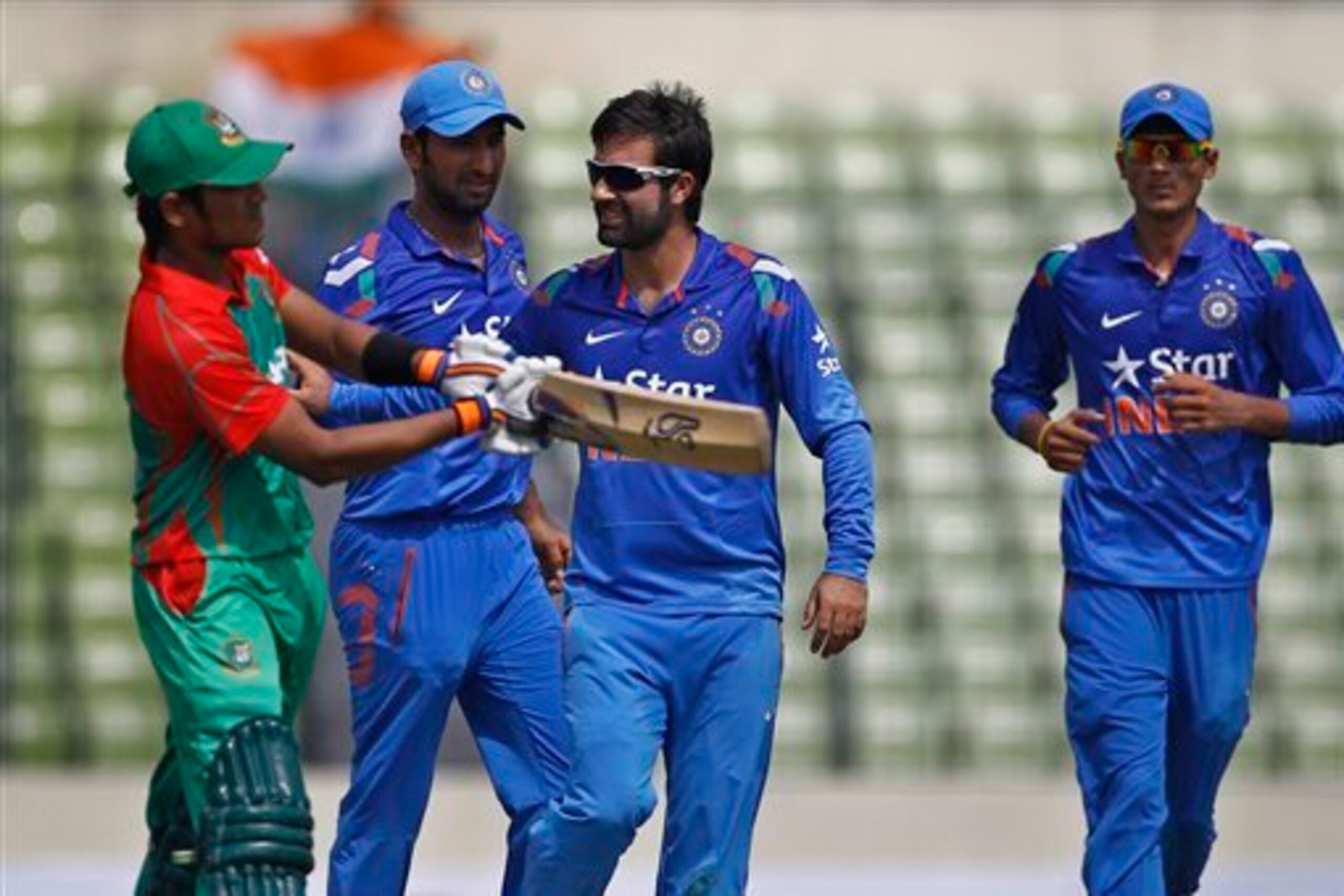 Parvez Rasool (second from right) and Akshar Patel (right) made their debuts for India.