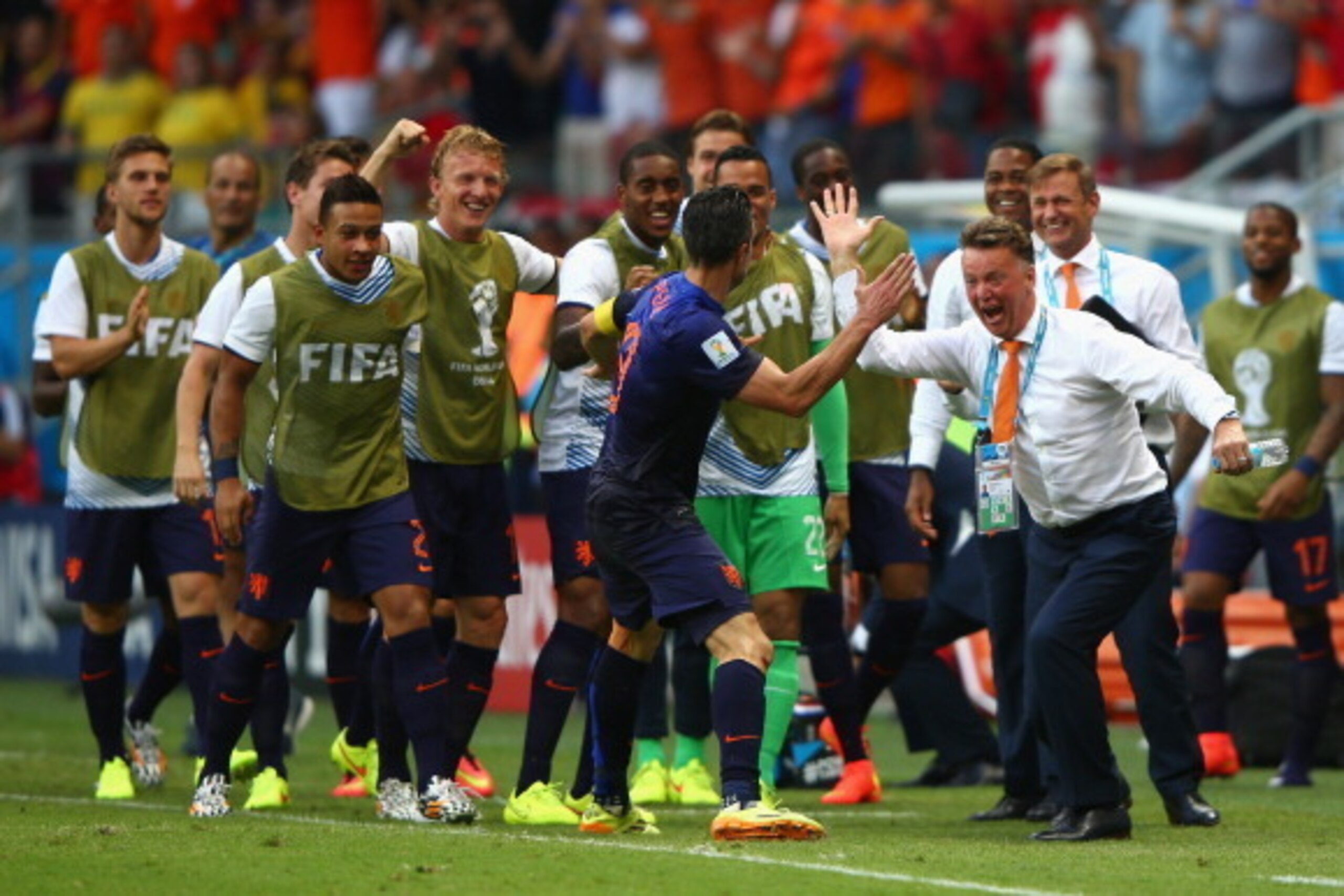 SALVADOR, BRAZIL - JUNE 13: Robin van Persie of the Netherlands (C) celebrates with head coach Louis van Gaal of the Netherlands (R) after scoring the team's first goal in the first half during the 2014 FIFA World Cup Brazil Group B match between Spain an