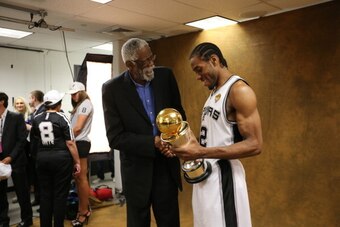 SAN ANTONIO, TX - JUNE 15: Kawhi Leonard #2 of the San Antonio Spurs and NBA Legend Bill Russell pose with the Bill Russell NBA Finals Most Valuable Player Award after Game Five of the 2014 NBA Finals against the Miami Heat at AT&T Center on June 15, 2014
