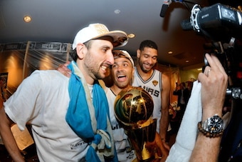 SAN ANTONIO, TX - JUNE 15: Manu Ginobili #20, Tony Parker #9, and Tim Duncan #21 of the San Antonio Spurs celebrate with the Larry O'Brien trophy after defeating the Miami Heat to win the 2014 NBA Finals in Game Five of the 2014 NBA Finals on June 15, 201