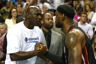 CHARLOTTE, NC - APRIL 28:  LeBron James #6 of the Miami Heat hugs Michael Jordan after defeating the Charlotte Bobcats 109-98 in Game Four of the Eastern Conference Quarterfinals during the 2014 NBA Playoffs at Time Warner Cable Arena on April 28, 2014 in