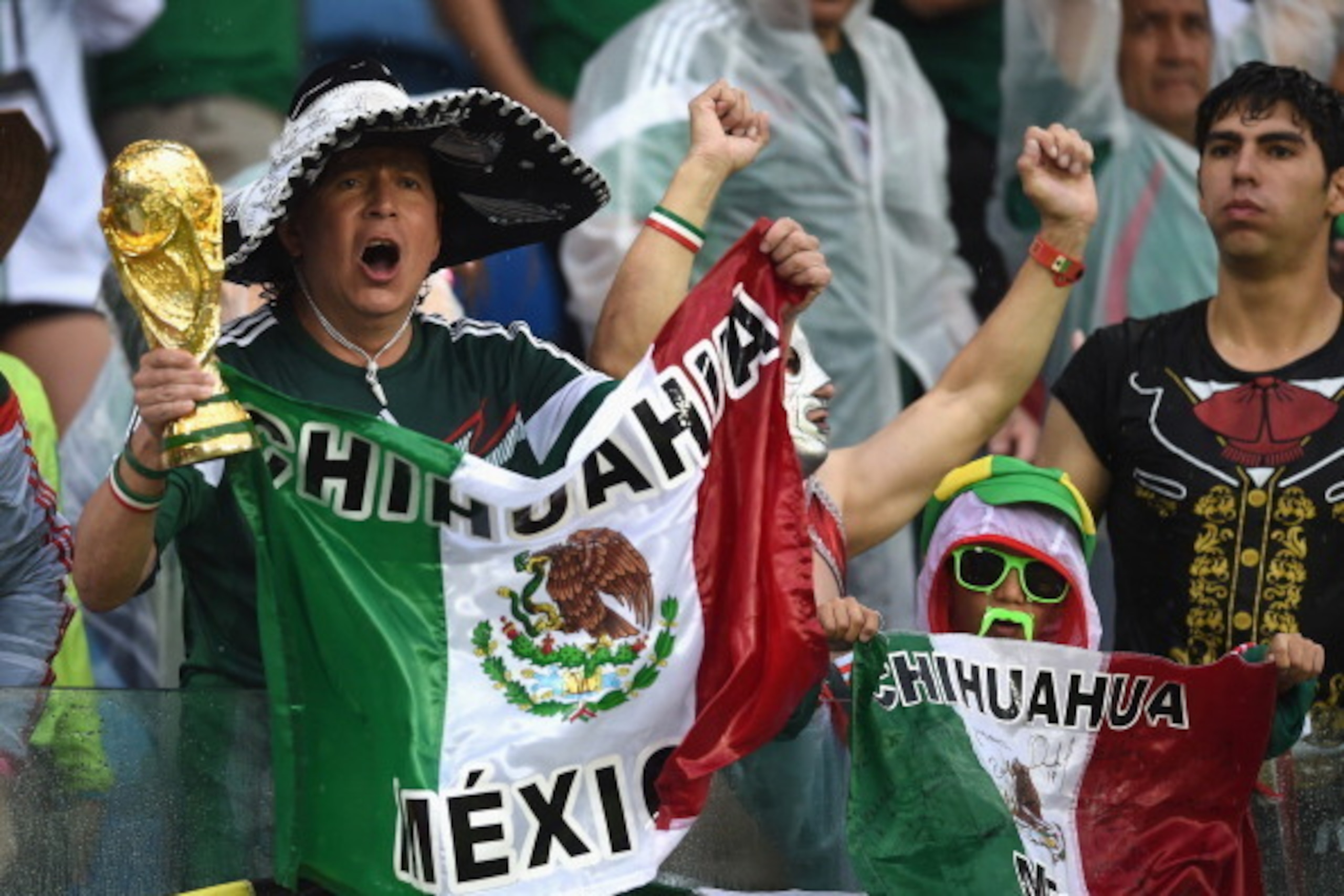NATAL, BRAZIL - JUNE 13: Mexico fans cheer during the 2014 FIFA World Cup Brazil Group A match between Mexico and Cameroon at Estadio das Dunas on June 13, 2014 in Natal, Brazil. (Photo by Matthias Hangst/Getty Images) NATAL, BRAZIL - JUNE 13: Mexico fans cheer during the 2014 FIFA World Cup Brazil Group A match between Mexico and Cameroon at Estadio das Dunas on June 13, 2014 in Natal, Brazil. (Photo by Matthias Hangst/Getty Images)
