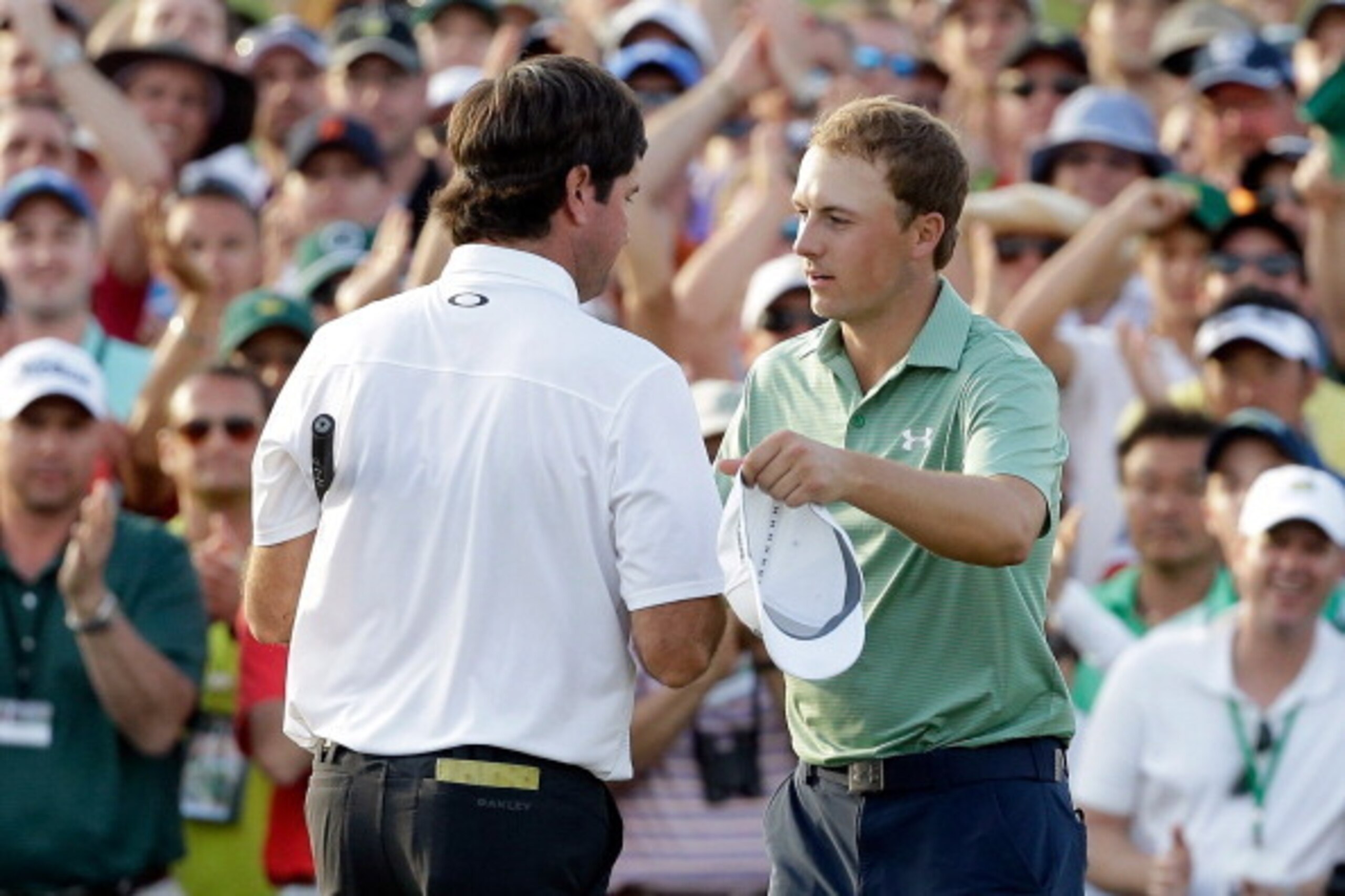 AUGUSTA, GA - APRIL 13:  Bubba Watson of the United States shakes hands with Jordan Spieth on the 18th green after Watson won the 2014 Masters Tournament by a three-stroke margin at Augusta National Golf Club on April 13, 2014 in Augusta, Georgia.  (Photo