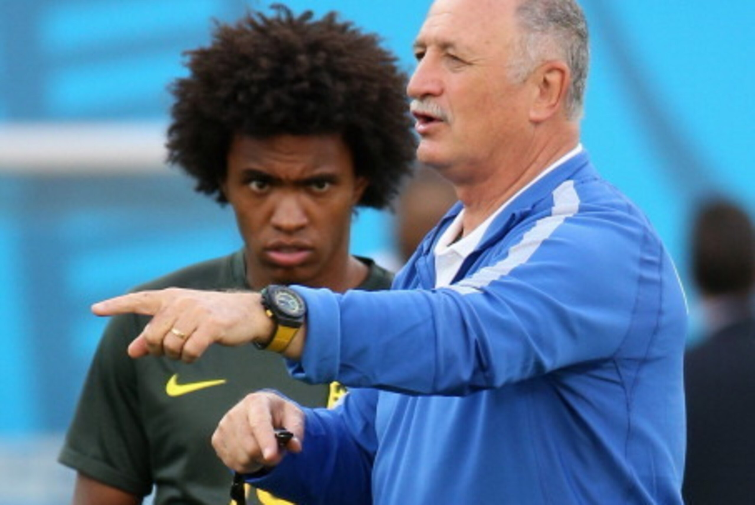 SAO PAULO, BRAZIL - JUNE 11: Manger Luiz Felipe Scolari of Brazil speaks as Willian looks on during a Brazil training session ahead of the 2014 FIFA World Cup Brazil opening match against Croatia at Arena de Sao Paulo on June 11, 2014 in Sao Paulo, Brazil