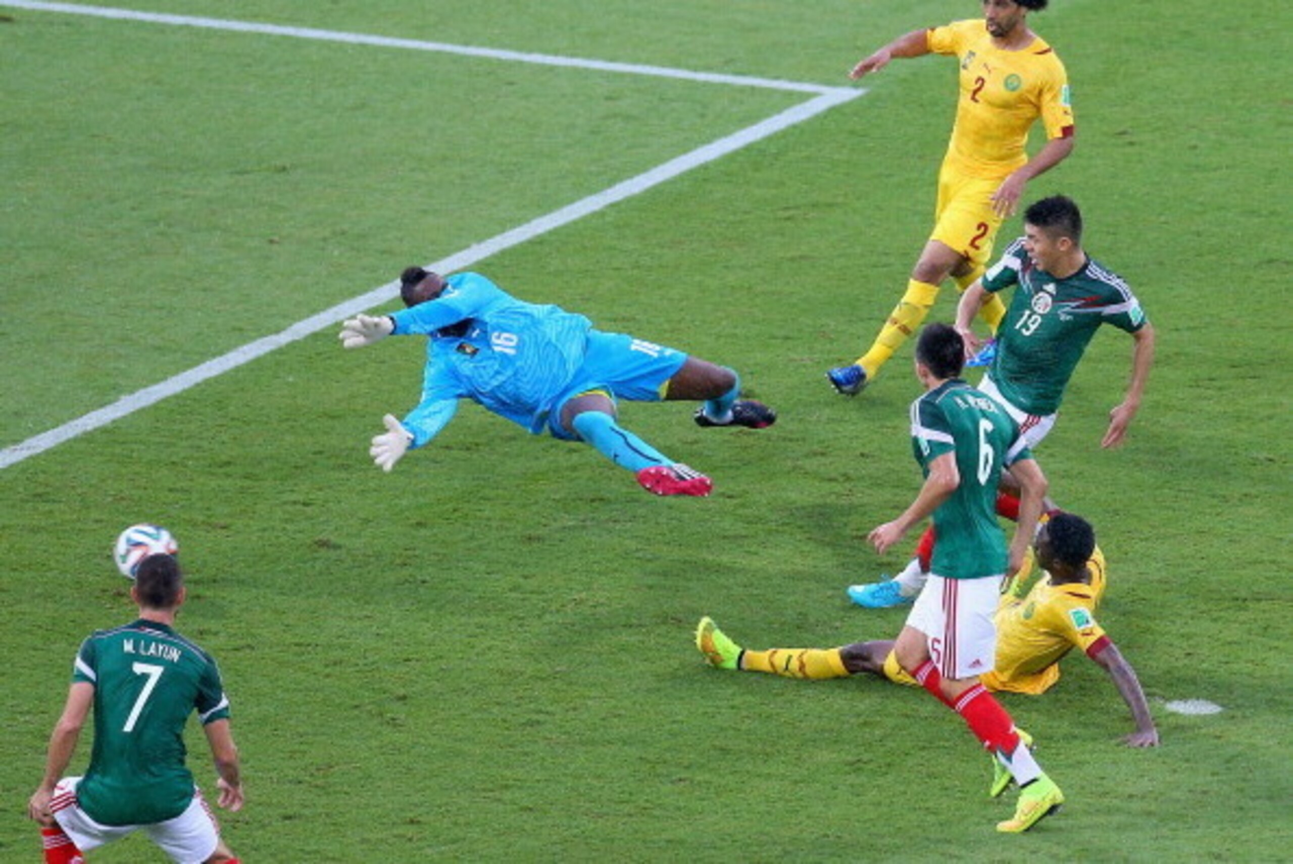 NATAL, BRAZIL - JUNE 13:  Oribe Peralta of Mexico shoots and scores a goal past goalkeeper Charles Itandje of Cameroon in the second half during the 2014 FIFA World Cup Brazil Group A match between Mexico and Cameroon at Estadio das Dunas on June 13, 2014