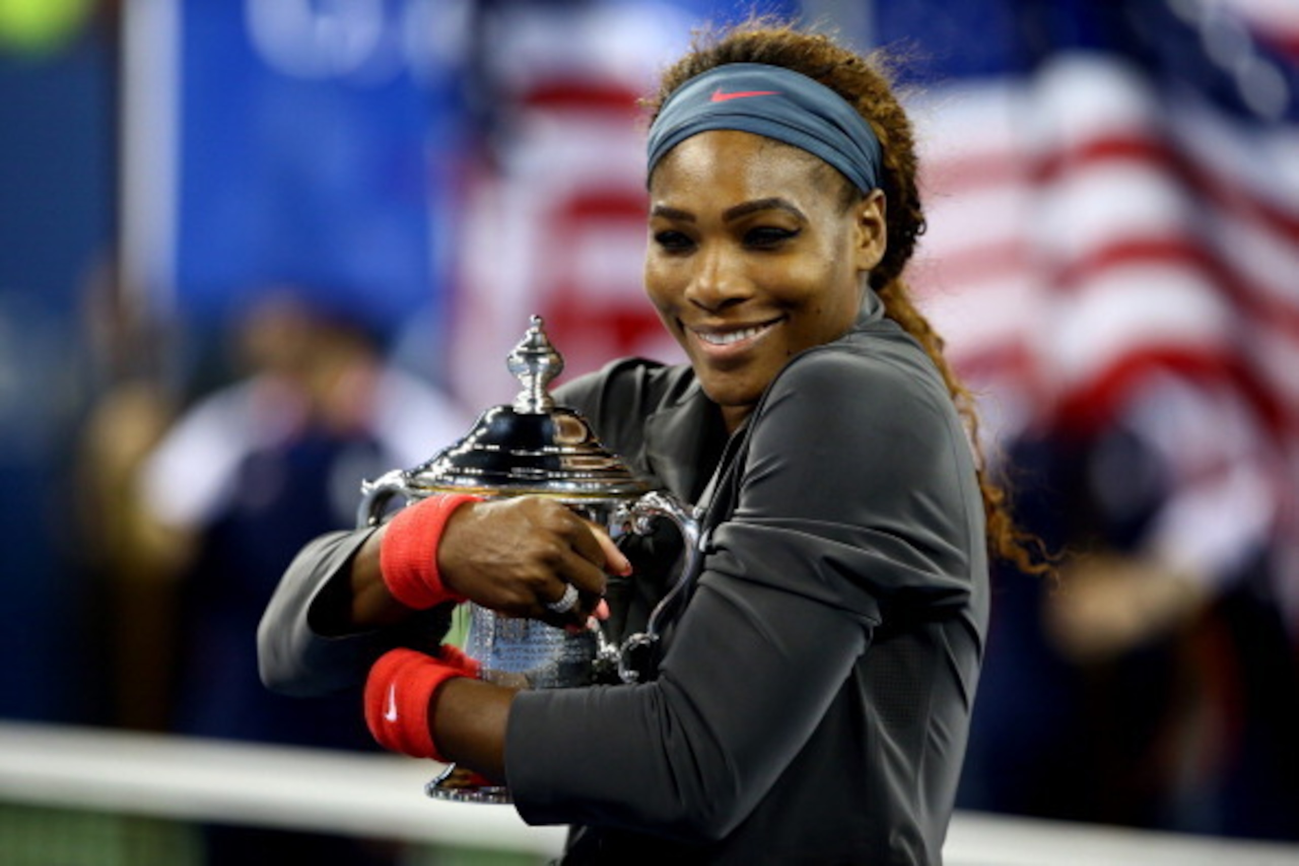 NEW YORK, NY - SEPTEMBER 08:  Serena Williams of the United States of America smiles as she poses with the trophy after winning her women's singles final match against Victoria Azarenka of Belarus on Day Fourteen of the 2013 US Open at the USTA Billie Jea