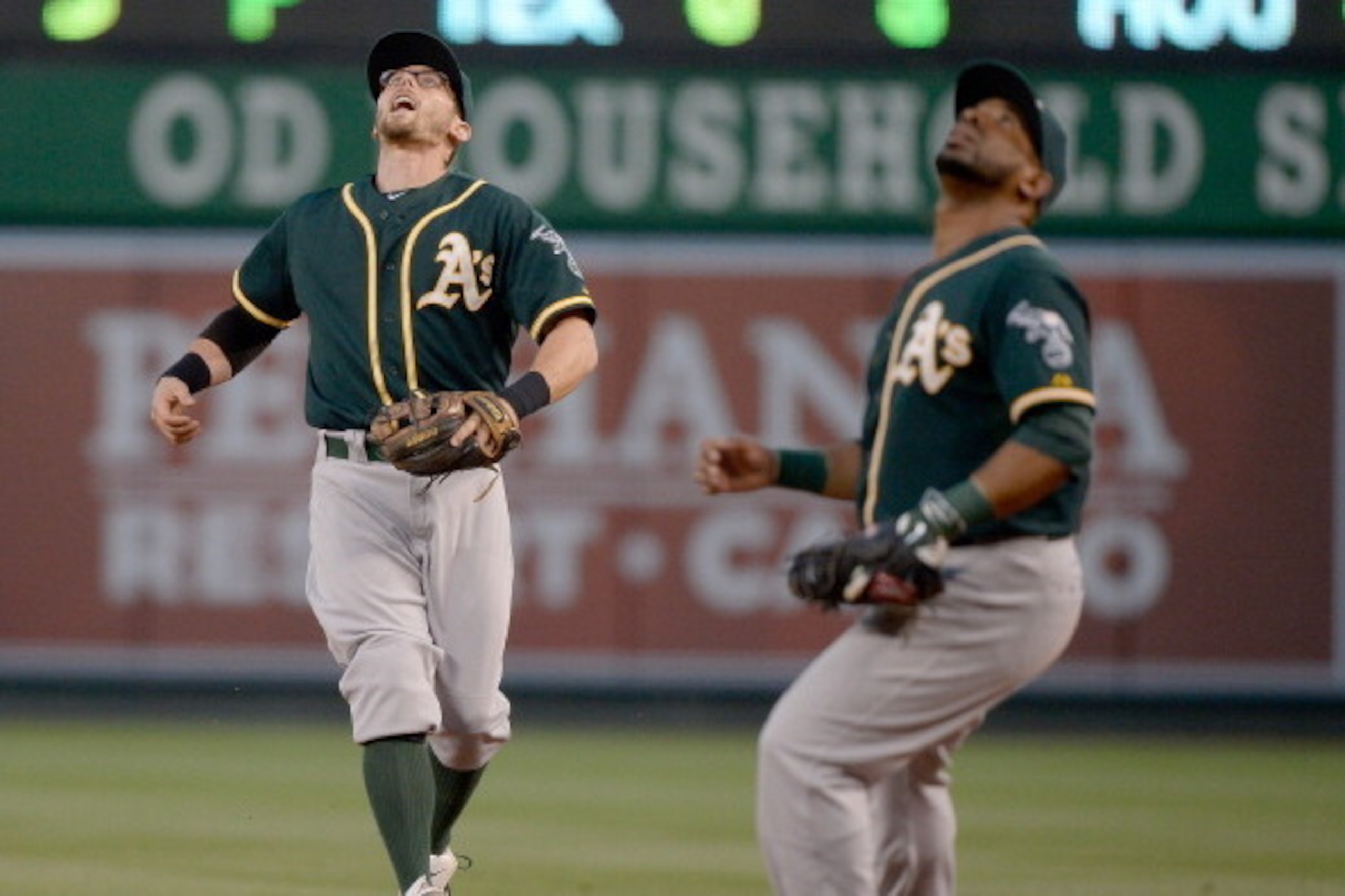 ANAHEIM, CA - APRIL 16: Eric Sogard #28 of the Oakland Athletics calls off Alberto Callaspo #18 to make a catch for an out of J.B. Shuck #3 of the Los Angeles Angels during the first inning at Angel Stadium of Anaheim on April 16, 2014 in Anaheim, Califo ANAHEIM, CA - APRIL 16: Eric Sogard #28 of the Oakland Athletics calls off Alberto Callaspo #18 to make a catch for an out of J.B. Shuck #3 of the Los Angeles Angels during the first inning at Angel Stadium of Anaheim on April 16, 2014 in Anaheim, Califo