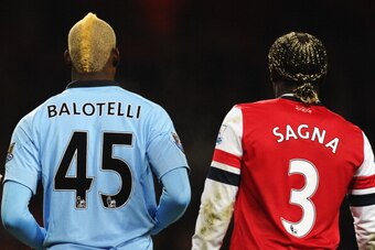 LONDON, ENGLAND - JANUARY 13:  Mario Balotelli of Manchester City and Bacary Sagna of Arsenal look on during the Barclays Premier League match between Arsenal and Manchester City at Emirates Stadium on January 13, 2013 in London, England.  (Photo by Mike 