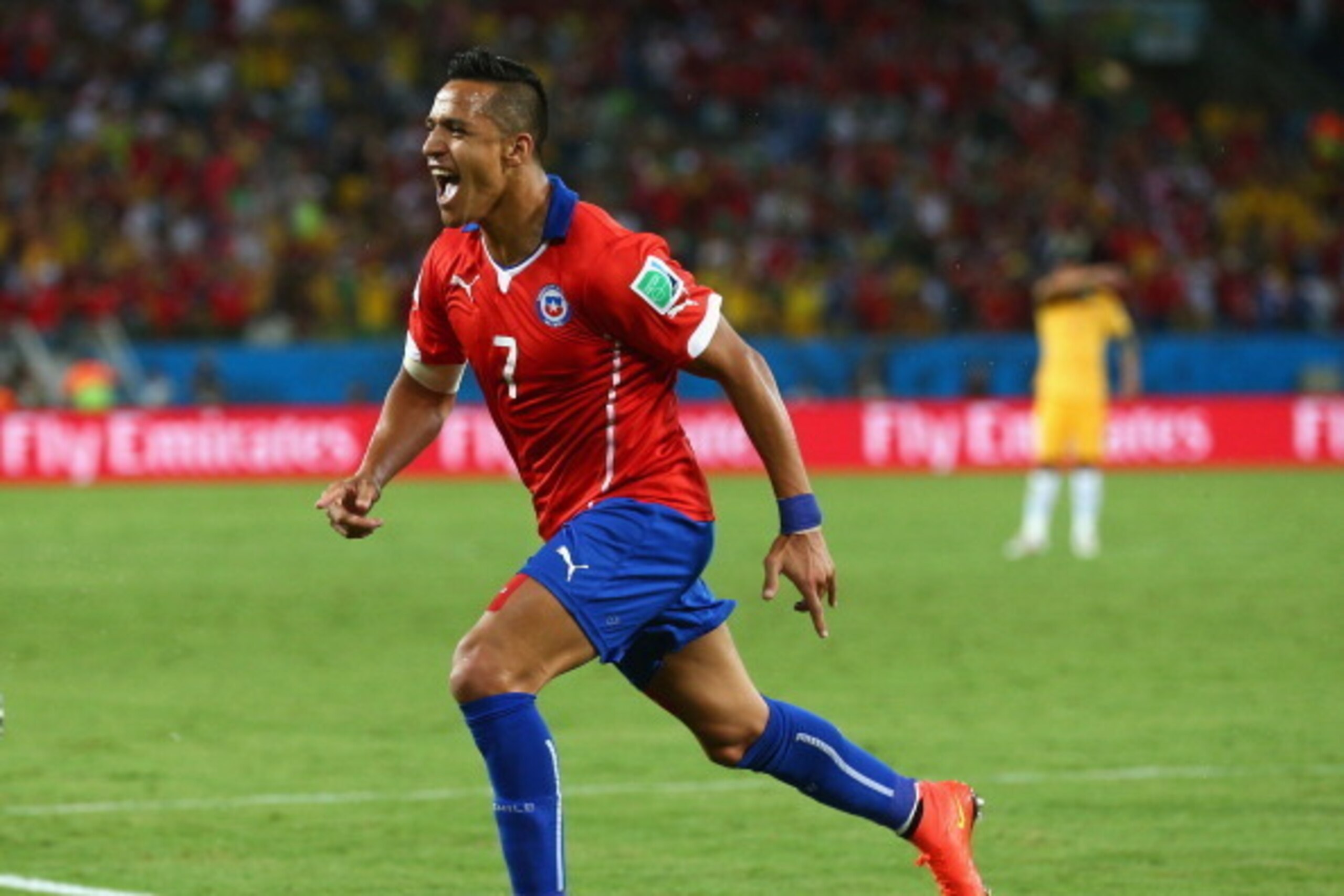 CUIABA, BRAZIL - JUNE 13:  Alexis Sanchez of Chile celebrates after scoring his team's first goal during the 2014 FIFA World Cup Brazil Group B match between Chile and Australia at Arena Pantanal on June 13, 2014 in Cuiaba, Brazil.  (Photo by Cameron Spen