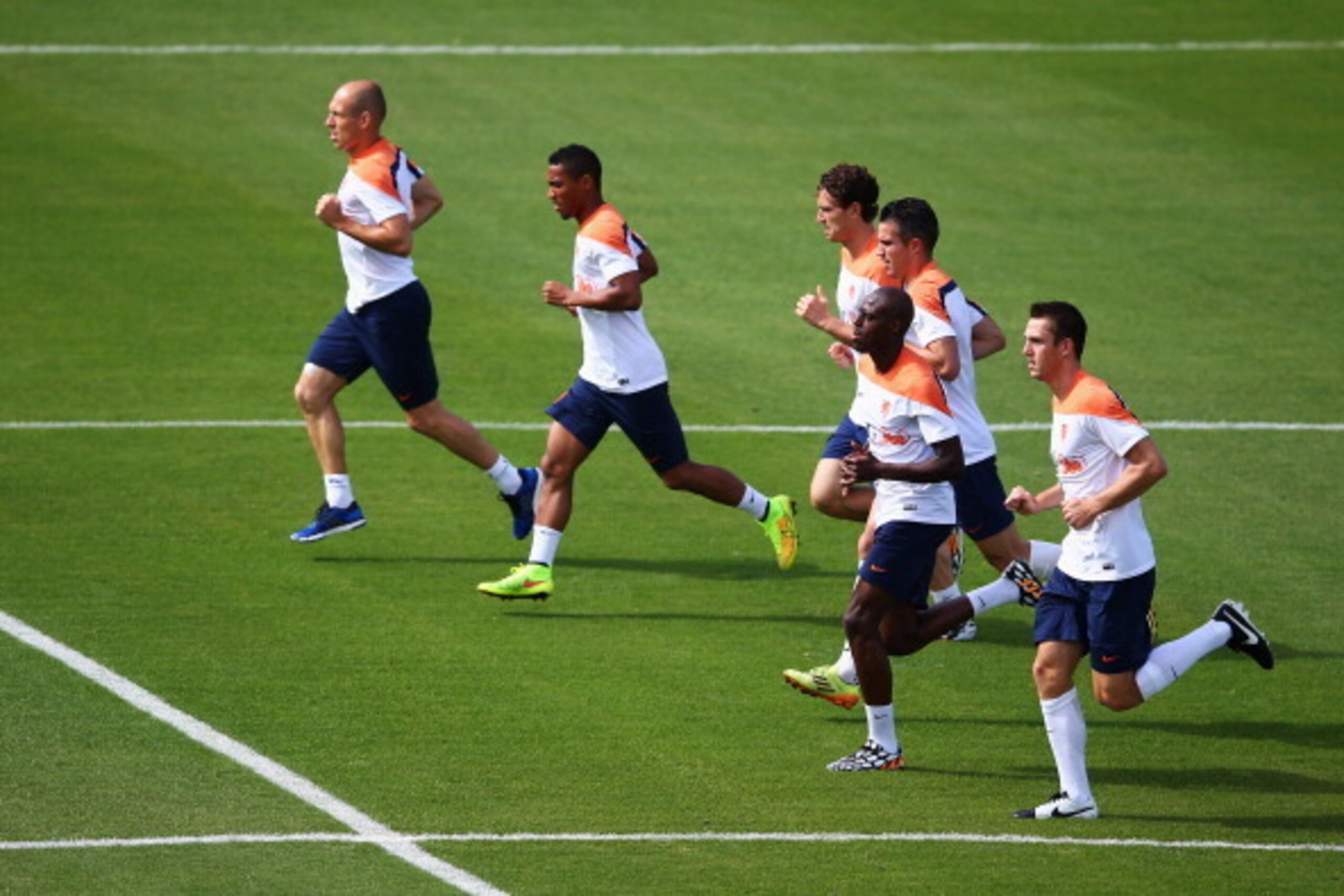 RIO DE JANEIRO, BRAZIL - JUNE 14:  Arjen Robben, Robin van Persie, Bruno Martins Indi, Daryl Janmaat Jonathan de Guzman and Stefan de Vrij warm up during the Netherlands training session at the 2014 FIFA World Cup Brazil held at the Estadio Jose Bastos Pa