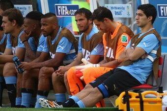 FORTALEZA, BRAZIL - JUNE 14: Luis Suarez of Uruguay (R) sits on the bench at the start of the 2014 FIFA World Cup Brazil Group D match between Uruguay and Costa Rica at Castelao on June 14, 2014 in Fortaleza, Brazil.  (Photo by Robert Cianflone/Getty Imag