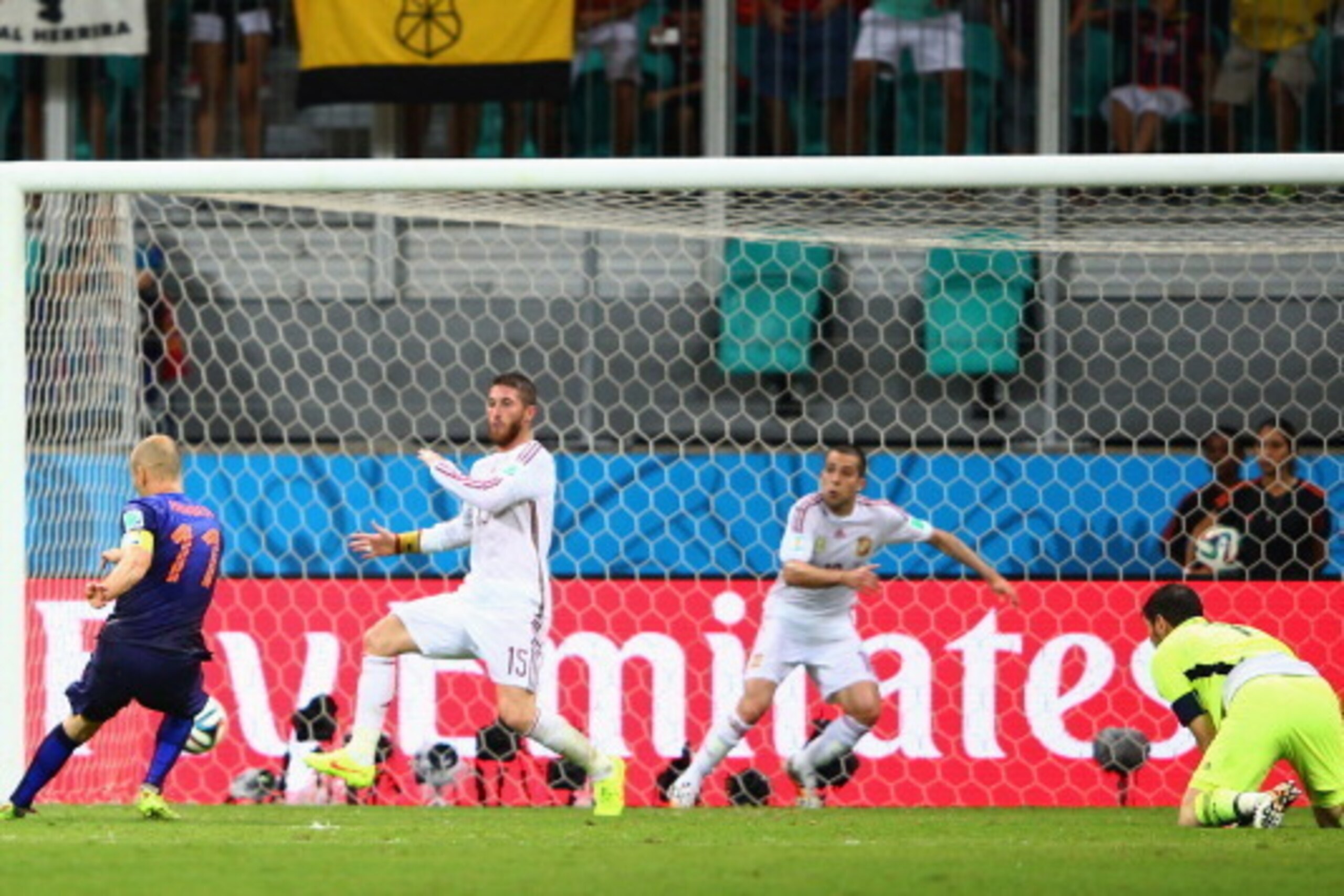 SALVADOR, BRAZIL - JUNE 13:  Arjen Robben of the Netherlands shoots and scores his second goal, the team's fifth, against Sergio Ramos (2nd L), Jordi Alba and goalkeeper Iker Casillas of Spain during the 2014 FIFA World Cup Brazil Group B match between Sp