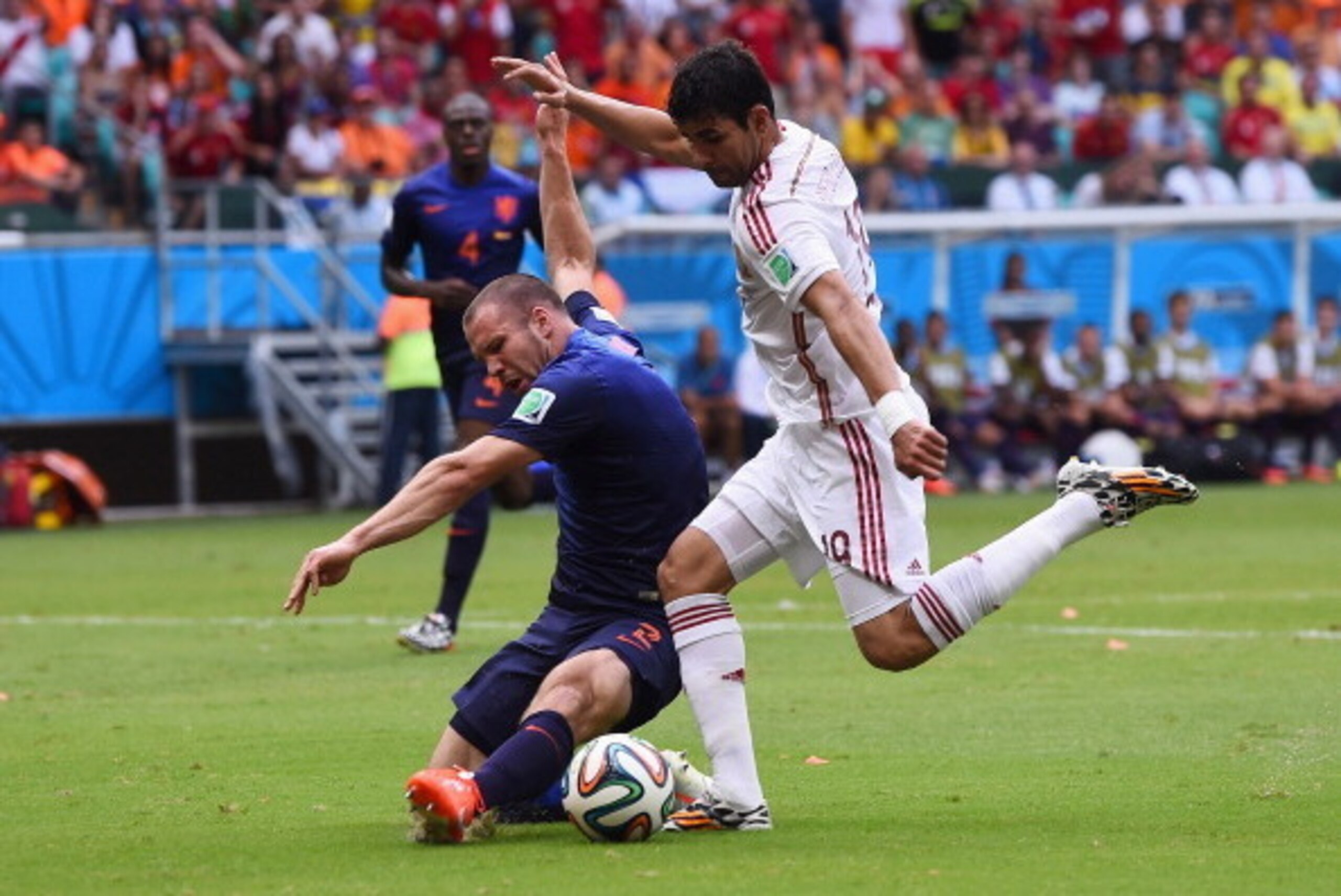 SALVADOR, BRAZIL - JUNE 13:  Diego Costa of Spain and Ron Vlaar of the Netherlands battle for the ball during the 2014 FIFA World Cup Brazil Group B match between Spain and Netherlands at Arena Fonte Nova on June 13, 2014 in Salvador, Brazil.  (Photo by D