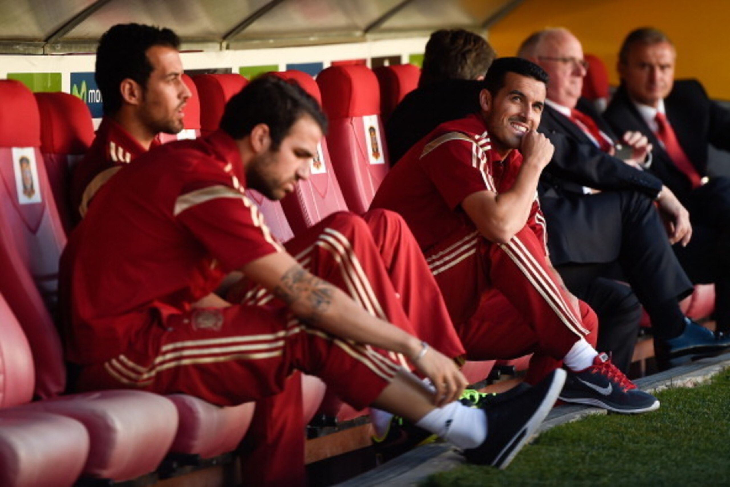 SEVILLE, SPAIN - MAY 30: (L-R) Sergi Busquets, Cesc Fabregas and Pedro Rodriguez of Spain look from the bench prior to an international friendly match between Spain and Bolivia at Estadio Ramon Sanchez Pizjuan on May 30, 2014 in Seville, Spain.  (Photo by