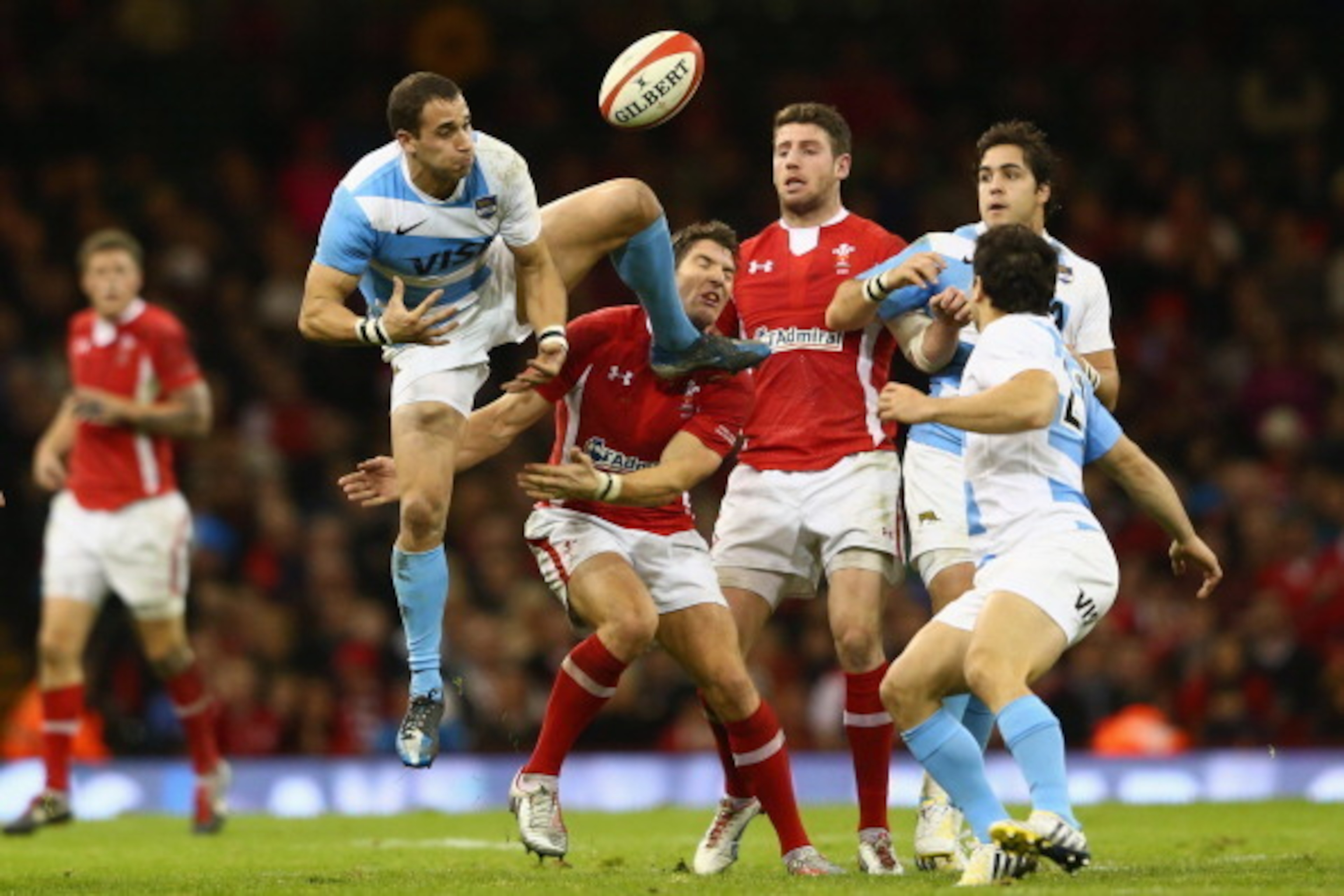 CARDIFF, WALES - NOVEMBER 10: Joaquin Tuculet (L) of Argentina spills a high ball under pressure from James Hook (C) of Wales during the Wales versus Argentina International match at the Millennium Stadium on November 10, 2012 in Cardiff, Wales.  (Photo b