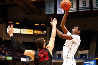 HARTFORD, CT - DECEMBER 18:  DeAndre Daniels #2 of the Connecticut Huskies takes a shot in front of Dwight Powell #33 of the Stanford Cardinal in the first half during the game at XL Center on December 18, 2013 in Hartford, Connecticut.  (Photo by Jared W