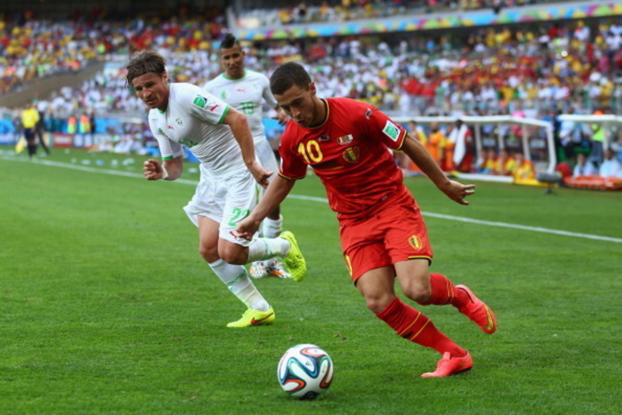 BELO HORIZONTE, BRAZIL - JUNE 17:  Eden Hazard of Belgium controls the ball as Mehdi Mostefa of Algeria gives chase during the 2014 FIFA World Cup Brazil Group H match between Belgium and Algeria at Estadio Mineirao on June 17, 2014 in Belo Horizonte, Bra
