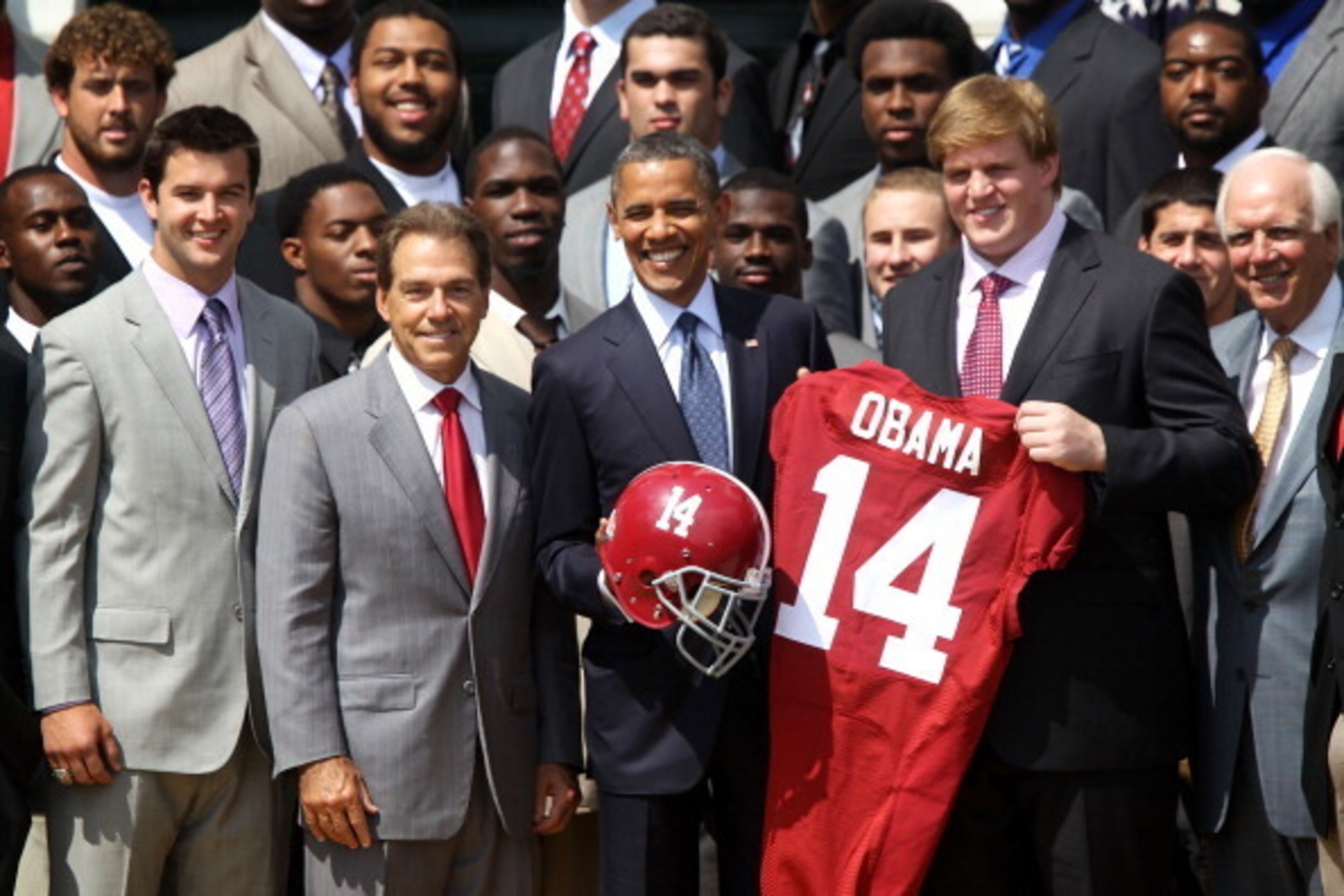 WASHINGTON, DC - APRIL 19:  U.S. President Barack Obama (3rd L) poses for a group picture with members of the University of Alabama Crimson Tide, including coach Nick Saban (2nd L), quarterback A.J. McCarron (L), and offensive lineman Barrett Jones (4th L