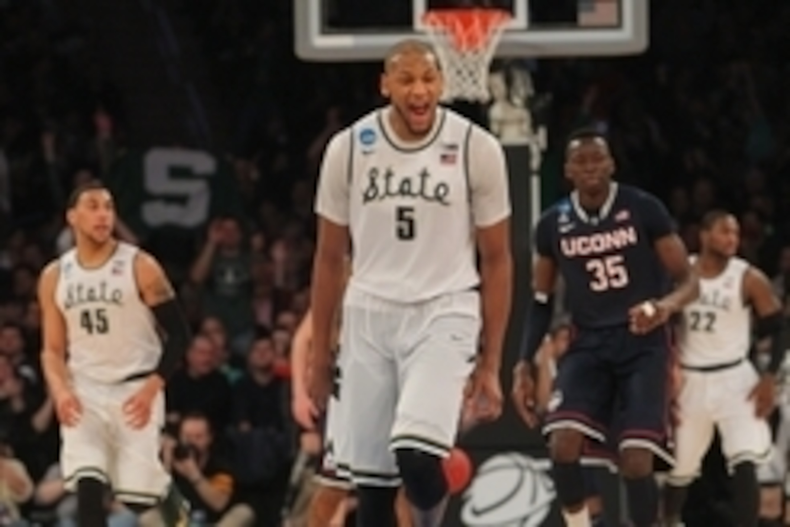 Mar 30, 2014; New York, NY, USA; Michigan State Spartans forward Adreian Payne (5) reacts after a three pointer against the Connecticut Huskies during the second half in the finals of the east regional of the 2014 NCAA Mens Basketball Championship tournam