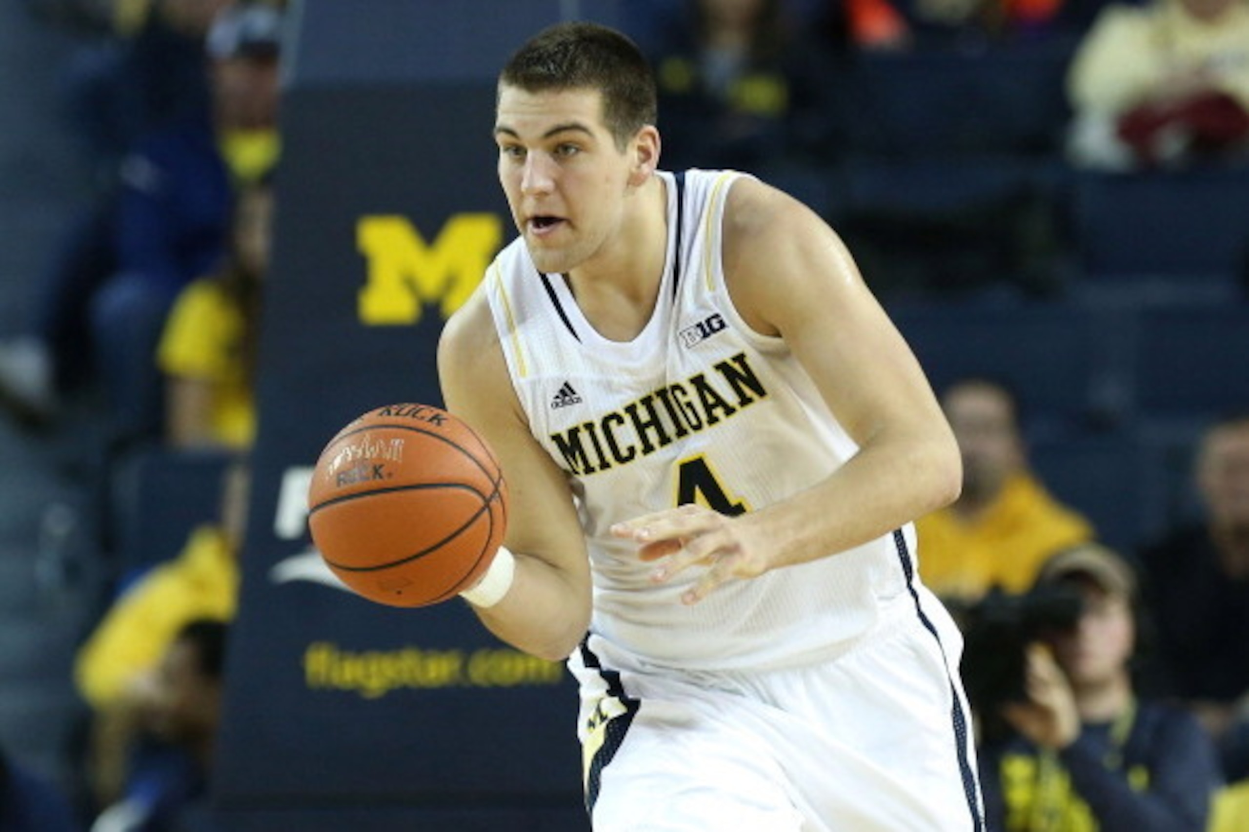 ANN ARBOR, MI - DECEMBER 07:  Mitch McGary #4 of the University of Michigan Wolverines drives the ball up the court during the second half of the game against Houston Baptist Huskies at the Crisler Center on December 7, 2013 in Ann Arbor, Michigan. Michig