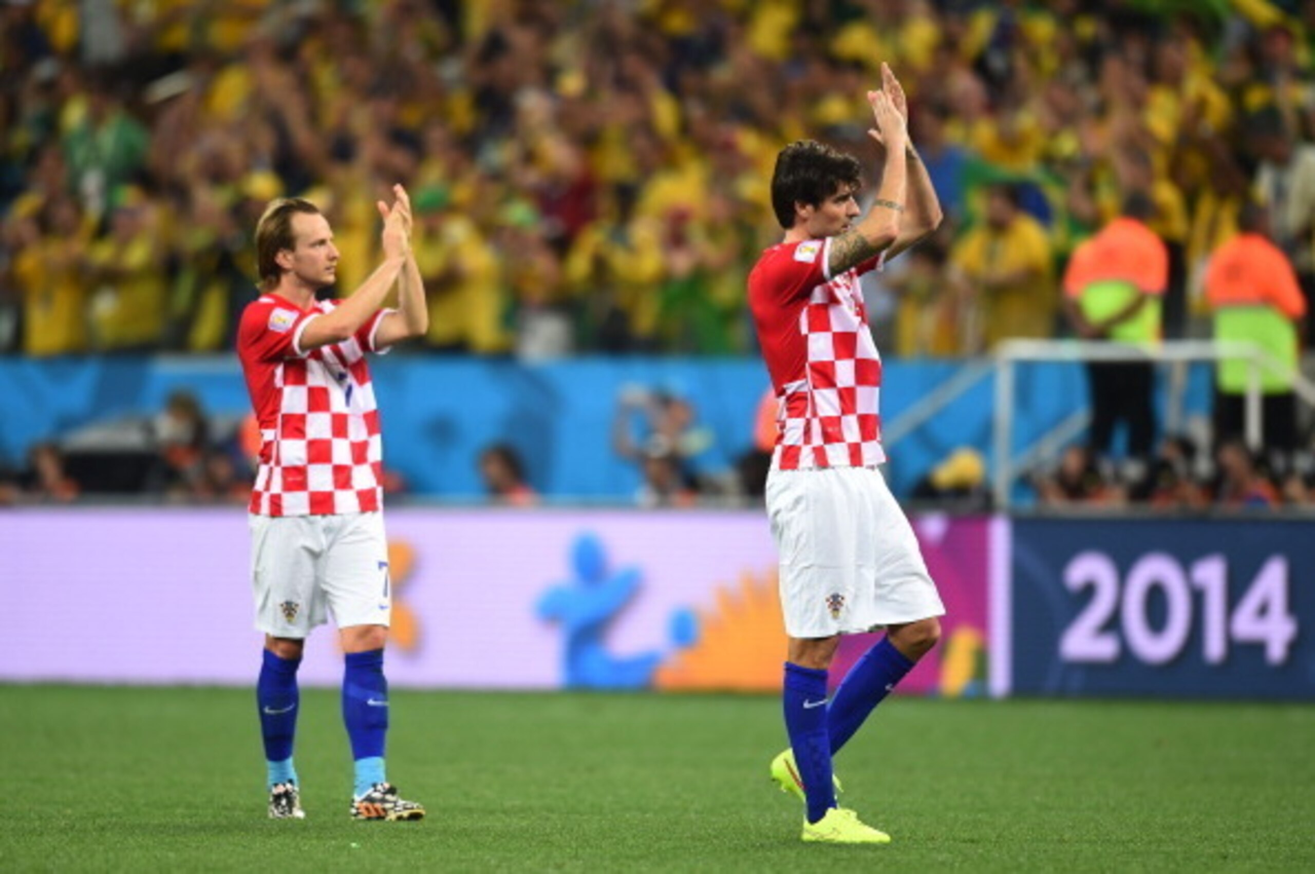 SAO PAULO, BRAZIL - JUNE 12: Ivan Rakitic (L) and Vedran Corluka of Croatia acknowledge the fans during the 2014 FIFA World Cup Brazil Group A match between Brazil and Croatia at Arena de Sao Paulo on June 12, 2014 in Sao Paulo, Brazil.  (Photo by Christo