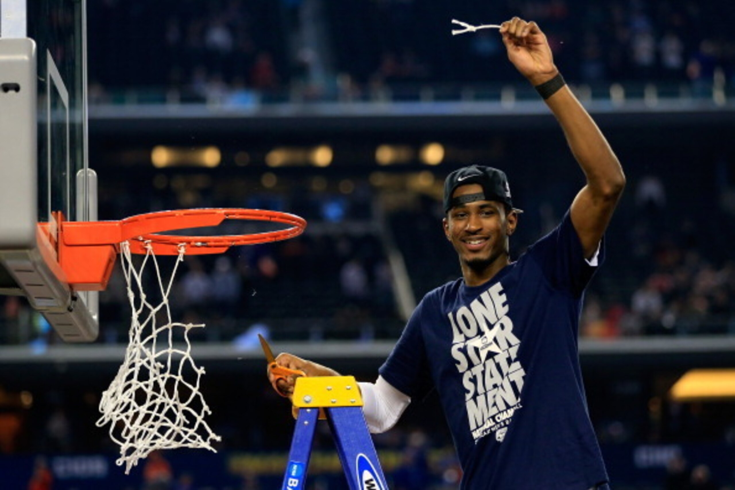 ARLINGTON, TX - APRIL 07:  DeAndre Daniels #2 of the Connecticut Huskies cuts the net after defeating the Kentucky Wildcats 60-54 in the NCAA Men's Final Four Championship at AT&T Stadium on April 7, 2014 in Arlington, Texas.  (Photo by Jamie Squire/Getty