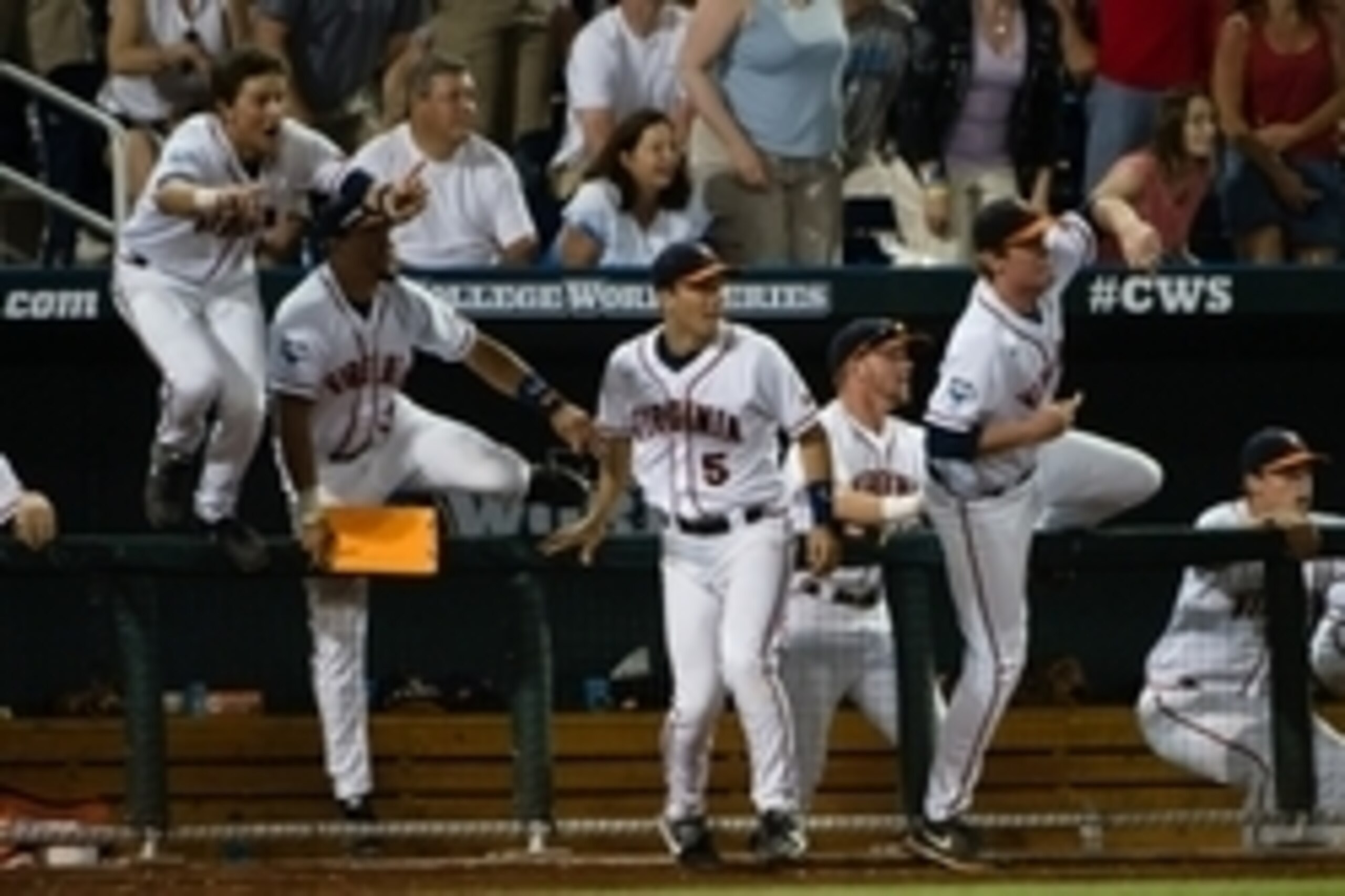 Jun 15, 2014; Omaha, NE, USA; The Virginia Cavaliers bench rushes the field as the winning run scores against the Mississippi Rebels during game four of the 2014 College World Series at TD Ameritrade Park Omaha. Virginia defeated Mississippi 2-1. Mandator