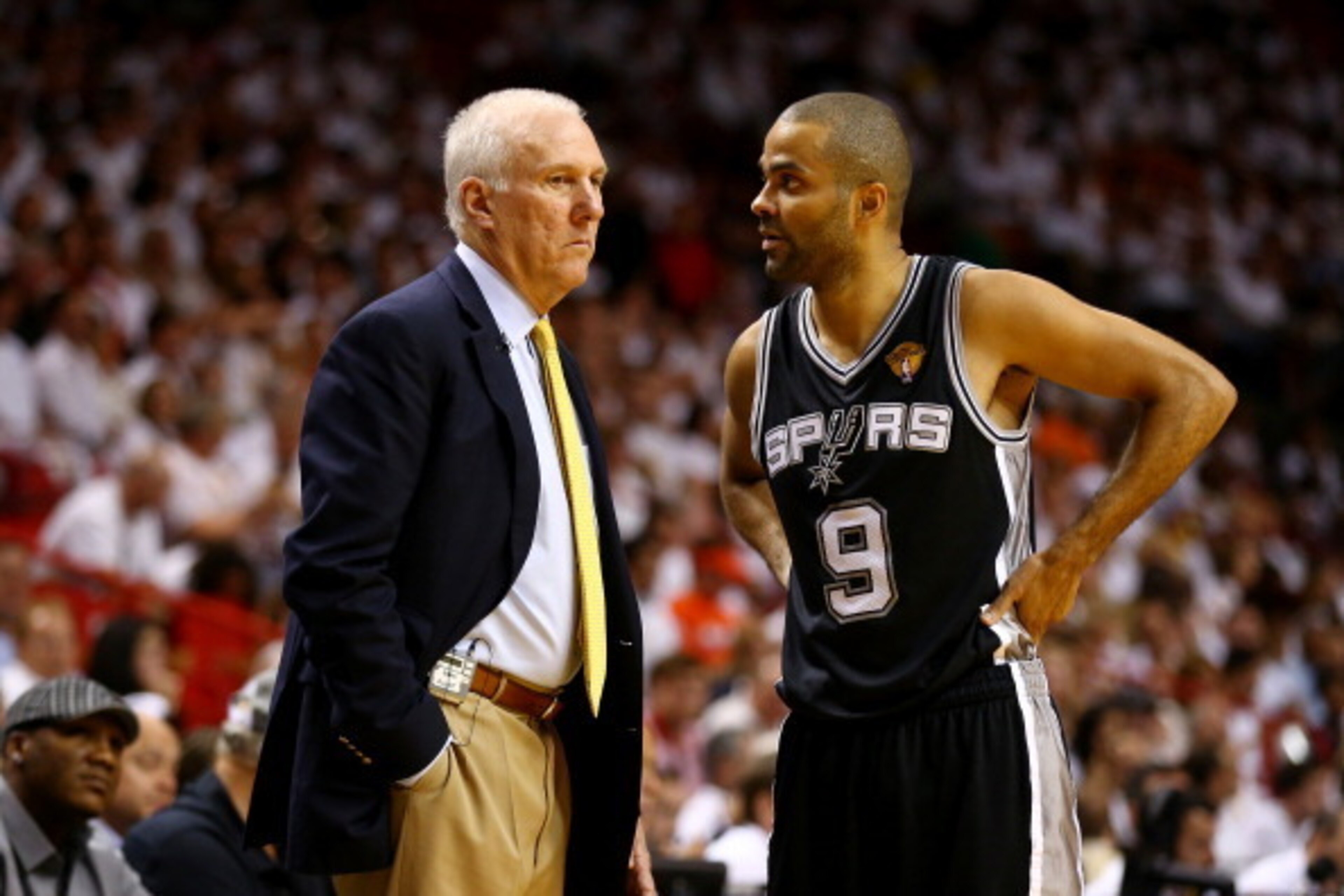 MIAMI, FL - JUNE 12:  Gregg Popovich speaks with Tony Parker #9 of the San Antonio Spurs during Game Four of the 2014 NBA Finals against the Miami Heat at American Airlines Arena on June 12, 2014 in Miami, Florida. NOTE TO USER: User expressly acknowledge