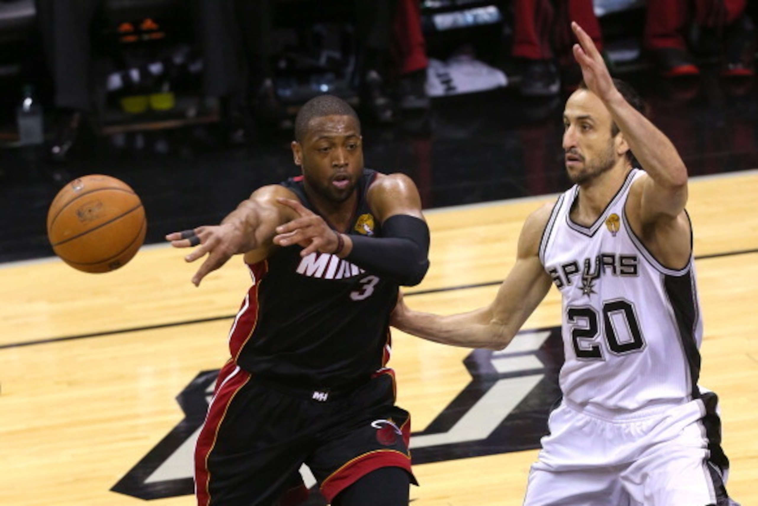 SAN ANTONIO, TX - JUNE 15: Dwyane Wade #3 of the Miami Heat passes the ball as Manu Ginobili #20 of the San Antonio Spurs defends him in Game Five of the 2014 NBA Finals at the AT&T Center on June 15, 2014 in San Antonio, Texas. NOTE TO USER: User expres SAN ANTONIO, TX - JUNE 15: Dwyane Wade #3 of the Miami Heat passes the ball as Manu Ginobili #20 of the San Antonio Spurs defends him in Game Five of the 2014 NBA Finals at the AT&T Center on June 15, 2014 in San Antonio, Texas. NOTE TO USER: User expres