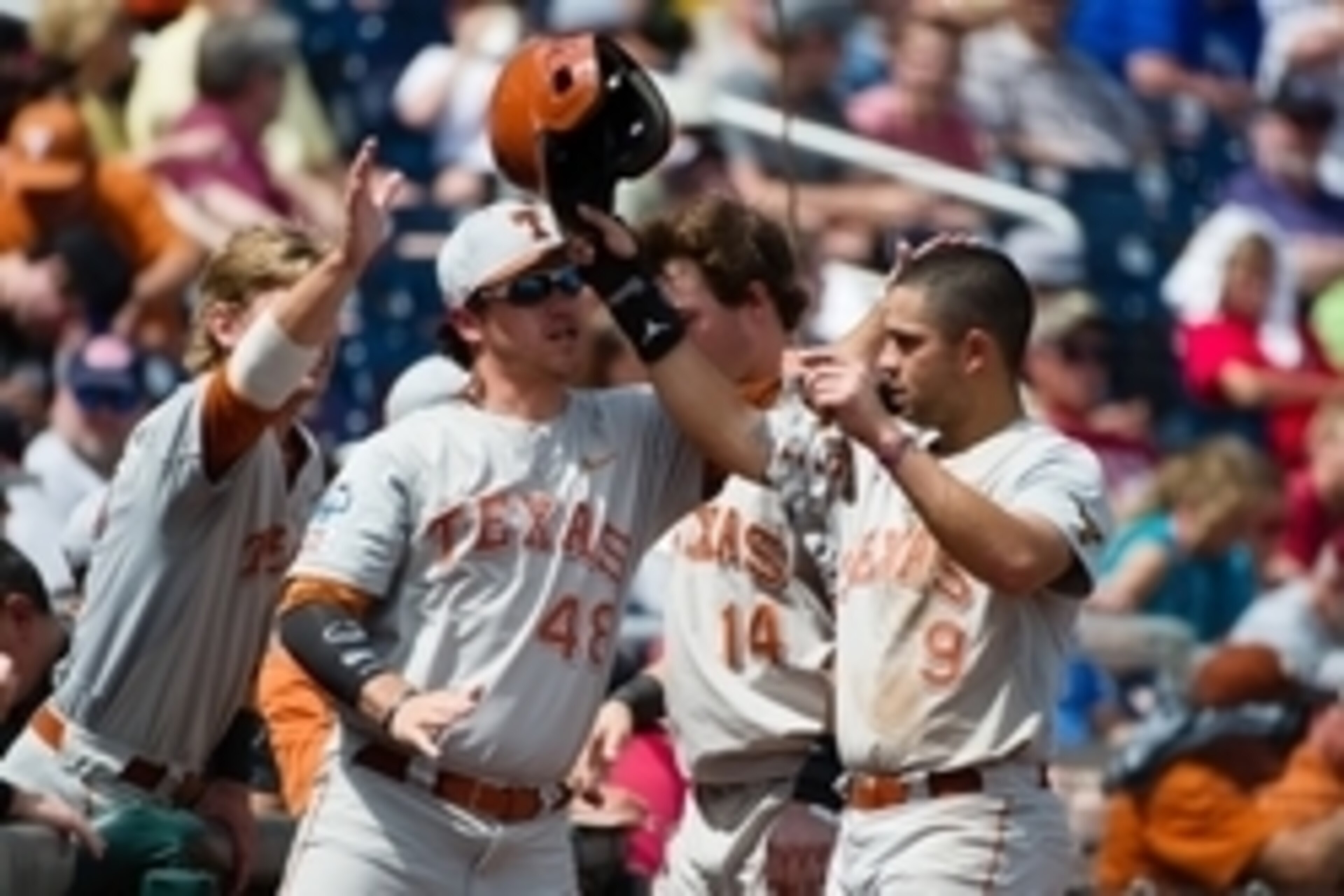 Jun 16, 2014; Omaha, NE, USA; Texas Longhorns pitcher Ty Marlow (48) greets infielder C.J. Hinojosa (9) after scoring against the Louisville Cardinals during game five of the 2014 College World Series at TD Ameritrade Park Omaha. Texas defeated Louisvill Jun 16, 2014; Omaha, NE, USA; Texas Longhorns pitcher Ty Marlow (48) greets infielder C.J. Hinojosa (9) after scoring against the Louisville Cardinals during game five of the 2014 College World Series at TD Ameritrade Park Omaha. Texas defeated Louisvill