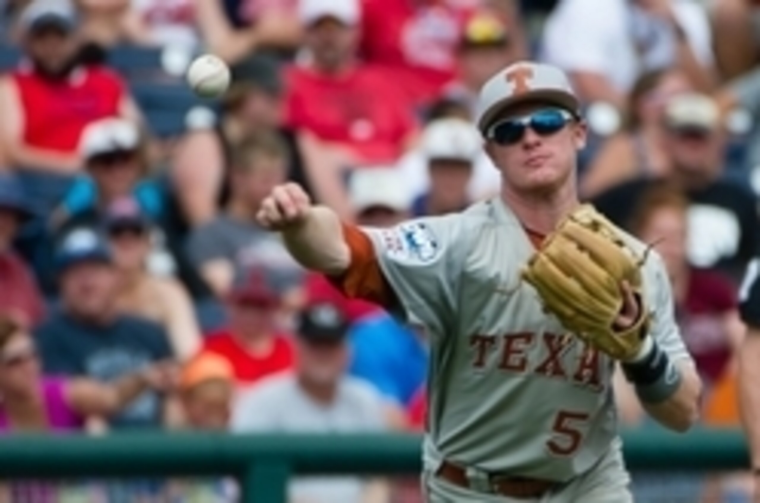 Jun 16, 2014; Omaha, NE, USA; Texas Longhorns infielder Zane Gurwitz (50) throws to first base against the Louisville Cardinals during game five of the 2014 College World Series at TD Ameritrade Park Omaha.  Texas defeated Louisville 4-1. Mandatory Credit