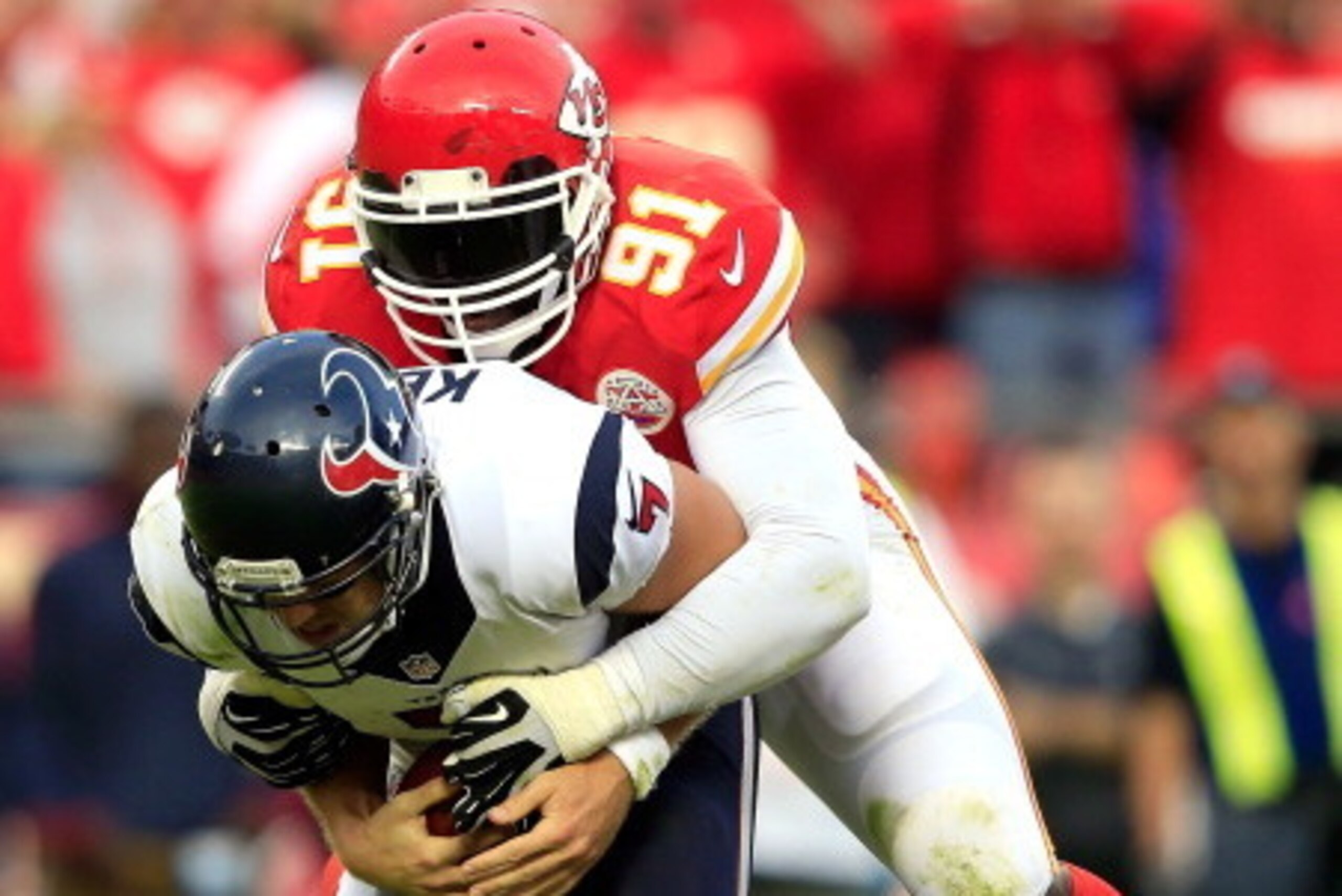 KANSAS CITY, MO - OCTOBER 20:  Outside linebacker Tamba Hali #91 of the Kansas City Chiefs sacks quarterback Case Keenum #7 of the Houston Texans late in the 2nd half of the game at Arrowhead Stadium on October 20, 2013 in Kansas City, Missouri.  (Photo b
