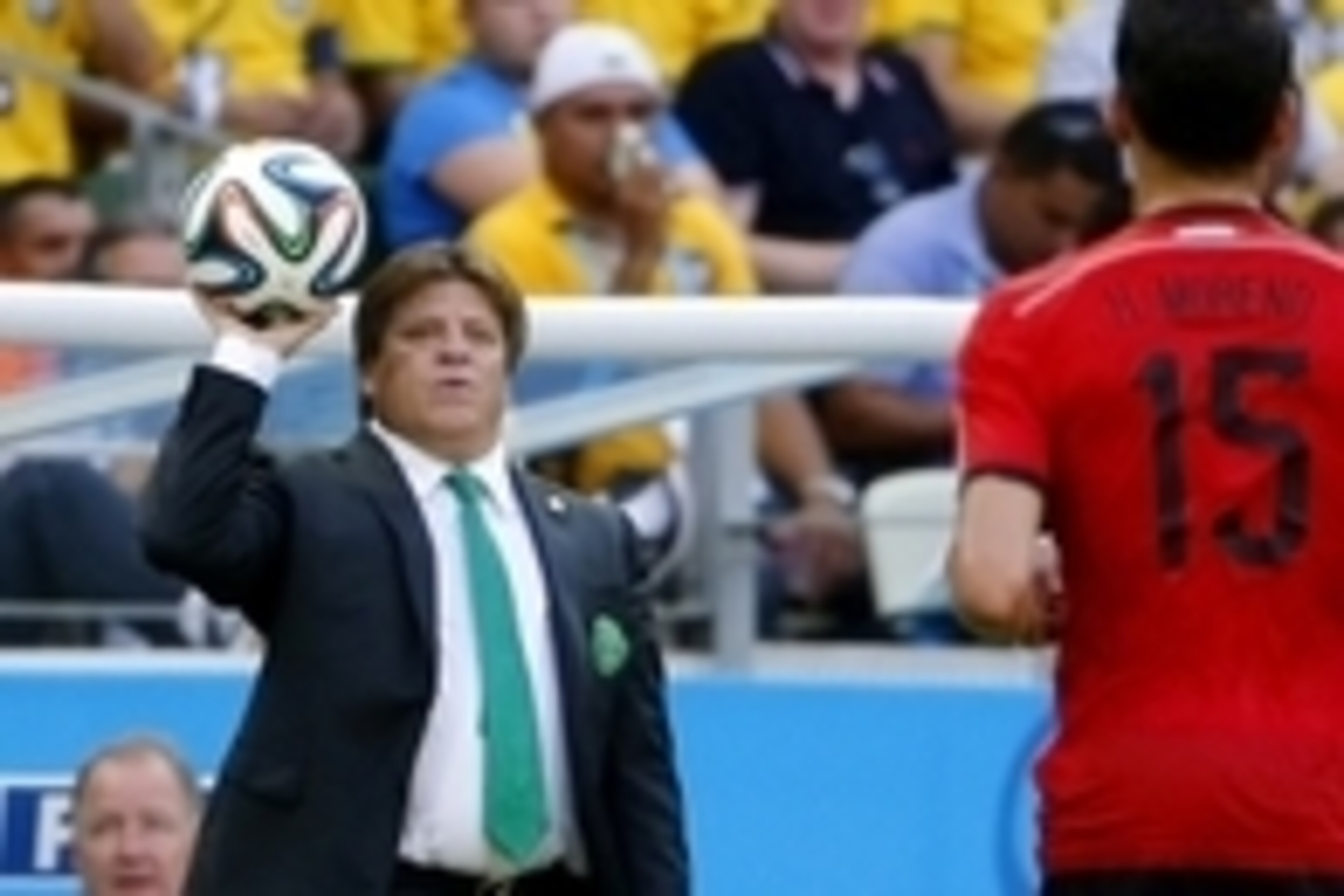 Jun 17, 2014; Fortaleza, Ceara, BRAZIL; Mexico manager Miguel Herrera tosses the ball to Mexico defender Hector Moreno (15) during the first half of the 2014 World Cup game against Brazil at Estadio Castelao. Mandatory Credit: Winslow Townson-USA TODAY Sp