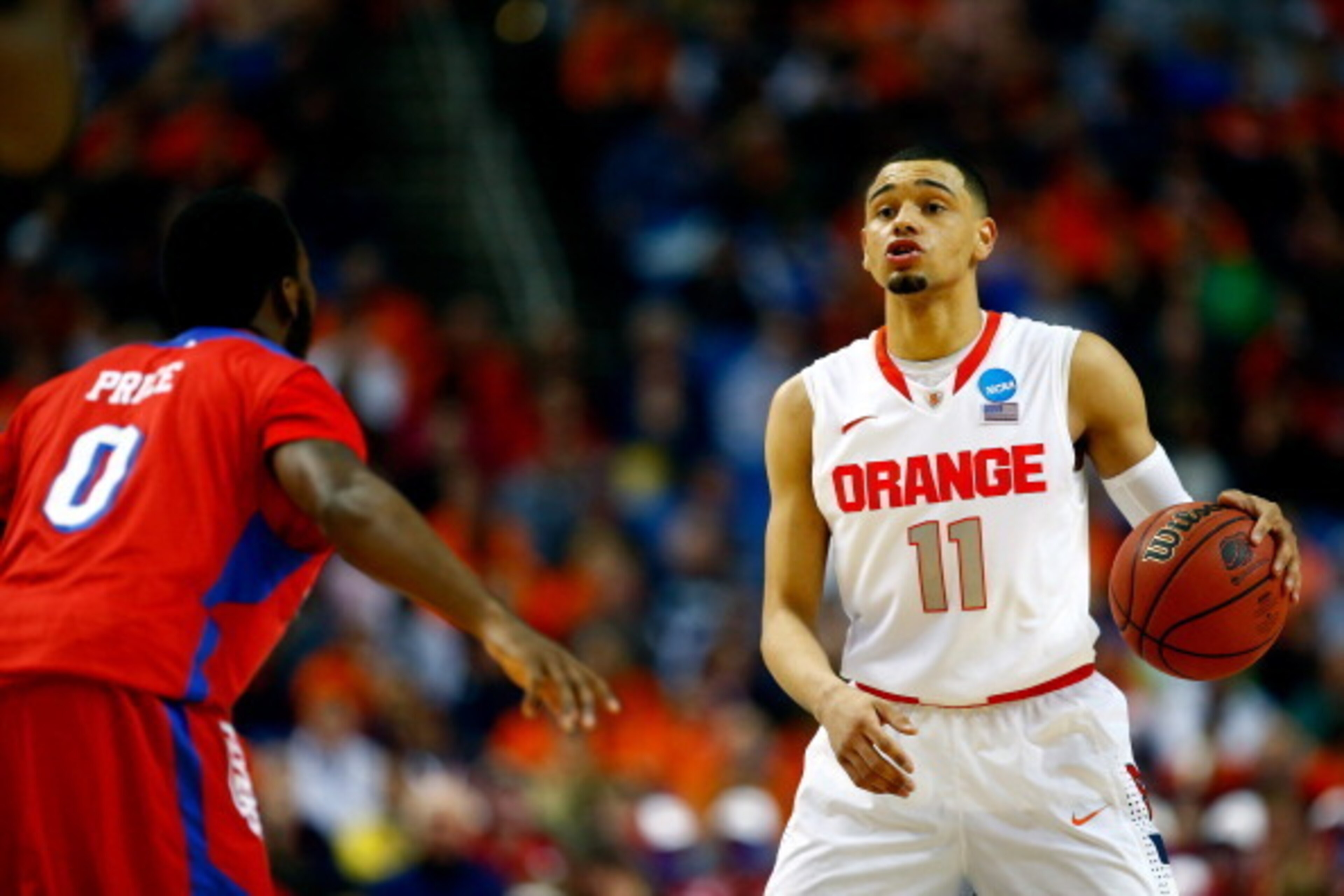 BUFFALO, NY - MARCH 22: Tyler Ennis #11 of the Syracuse Orange calls a play as Khari Price #0 of the Dayton Flyers defends during the third round of the 2014 NCAA Men's Basketball Tournament at the First Niagara Center on March 22, 2014 in Buffalo, New Yo BUFFALO, NY - MARCH 22: Tyler Ennis #11 of the Syracuse Orange calls a play as Khari Price #0 of the Dayton Flyers defends during the third round of the 2014 NCAA Men's Basketball Tournament at the First Niagara Center on March 22, 2014 in Buffalo, New Yo
