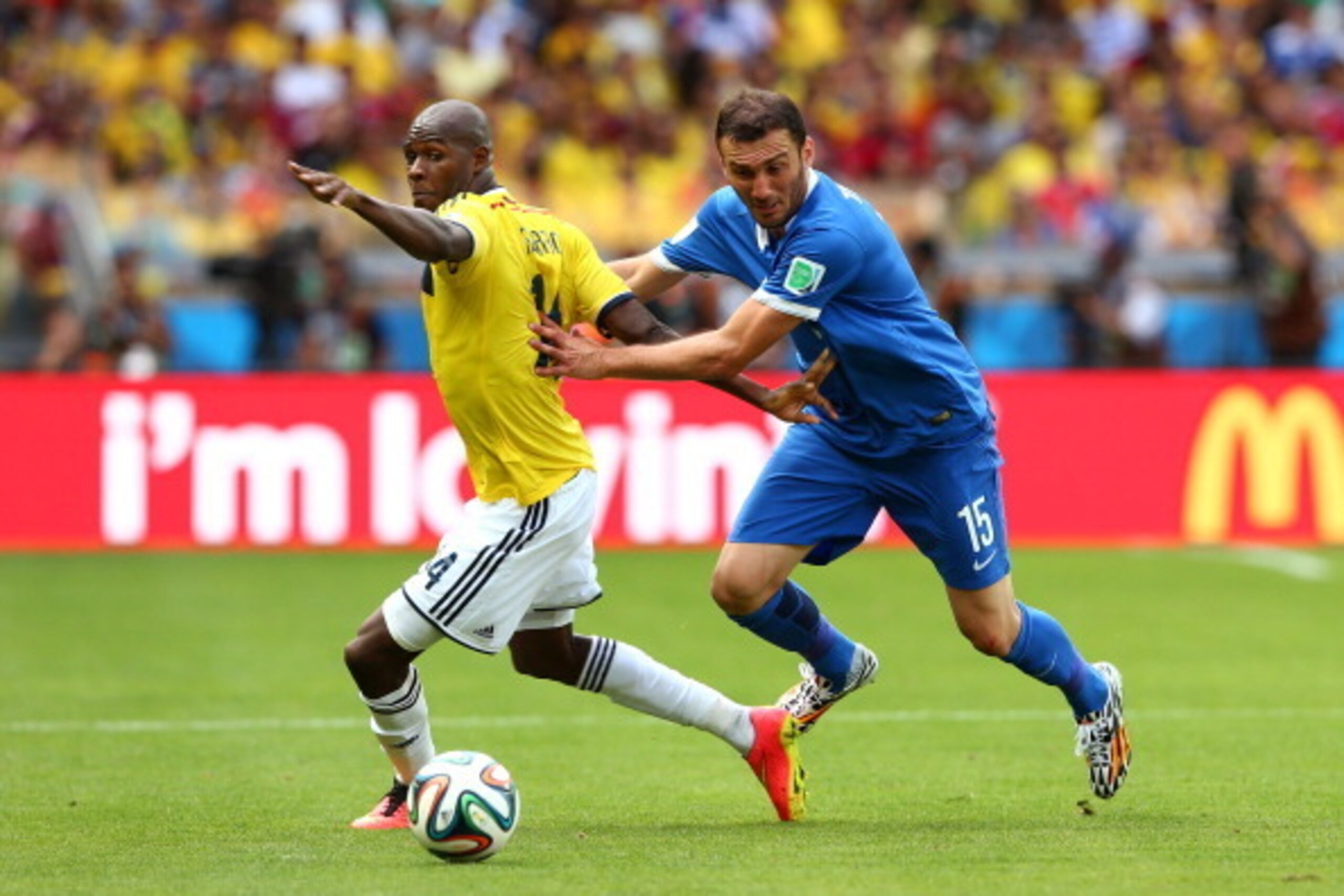 BELO HORIZONTE, BRAZIL - JUNE 14: Victor Ibarbo of Colombia is challenged by Vasilis Torosidis of Greece during the 2014 FIFA World Cup Brazil Group C match between Colombia and Greece at Estadio Mineirao on June 14, 2014 in Belo Horizonte, Brazil.  (Phot