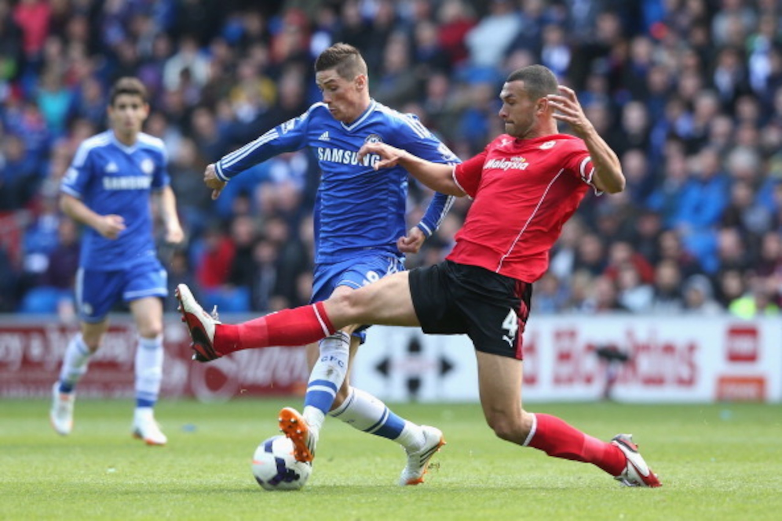 CARDIFF, WALES - MAY 11:  Fernando Torres of Chelsea is challenged by Steven Caulker (R) during the Barclays Premier League match between Cardiff City and Chelsea at the Cardiff City Stadium on May 11, 2014 in Cardiff, Wales.  (Photo by David Rogers/Getty