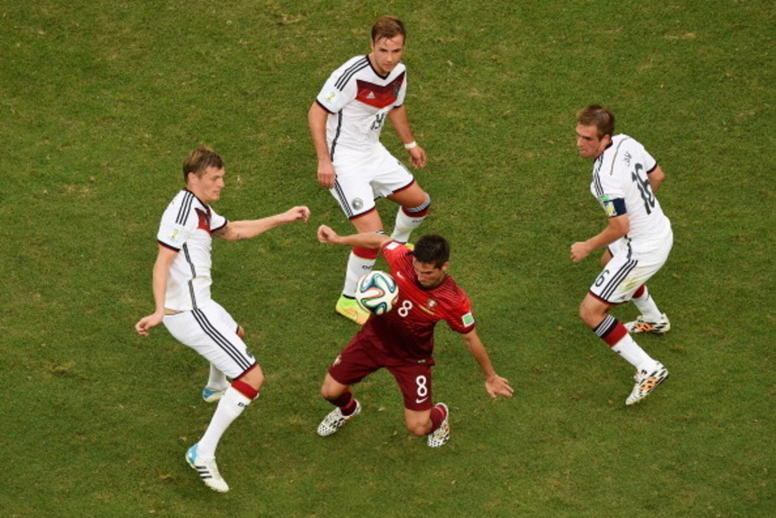 SALVADOR, BRAZIL - JUNE 16:  Joao Moutinho of Portugal takes on Toni Kroos of Germany, Mario Goetze and Philipp Lahm during the 2014 FIFA World Cup Brazil Group G match between Germany and Portugal at Arena Fonte Nova on June 16, 2014 in Salvador, Brazil.