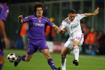FLORENCE, ITALY - SEPTEMBER 29:  Fabio Aurelio of Liverpool shoots past Stevan Jovetic of Fiorentina during the UEFA Champions League Group E match between Fiorentina and Liverpool at the Stadio Artemio Franchi stadium on September 29, 2009 in Florence, I