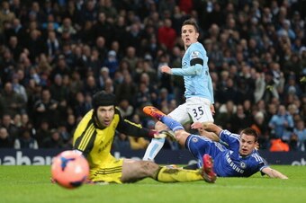 MANCHESTER, ENGLAND - FEBRUARY 15:  Steven Jovetic of Manchester City scores the first goal past Petr Cech of Chelsea during the FA Cup Fifth Round match sponsored by Budweiser between Manchester City and Chelsea at Etihad Stadium on February 15, 2014 in 